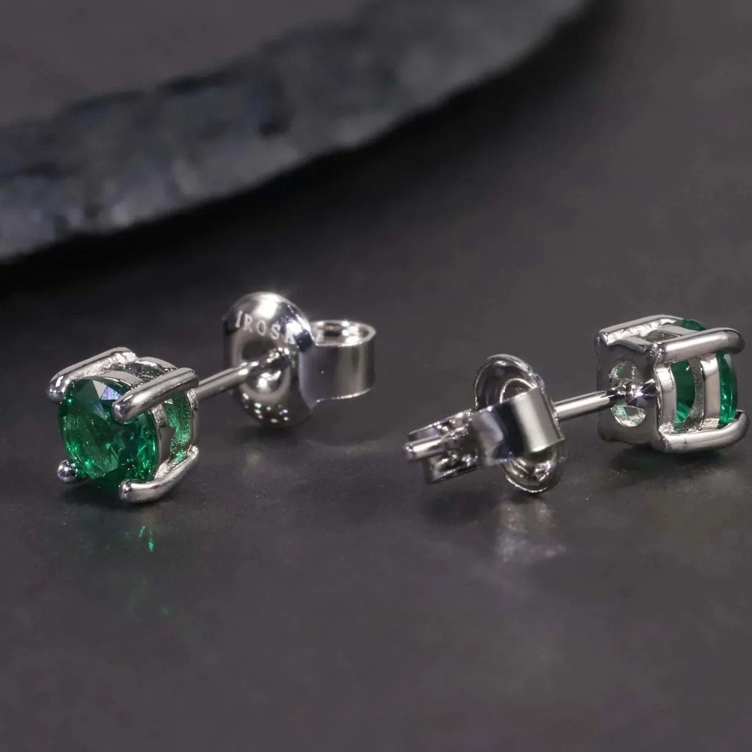 round emerald studs representing emerald earrings collection