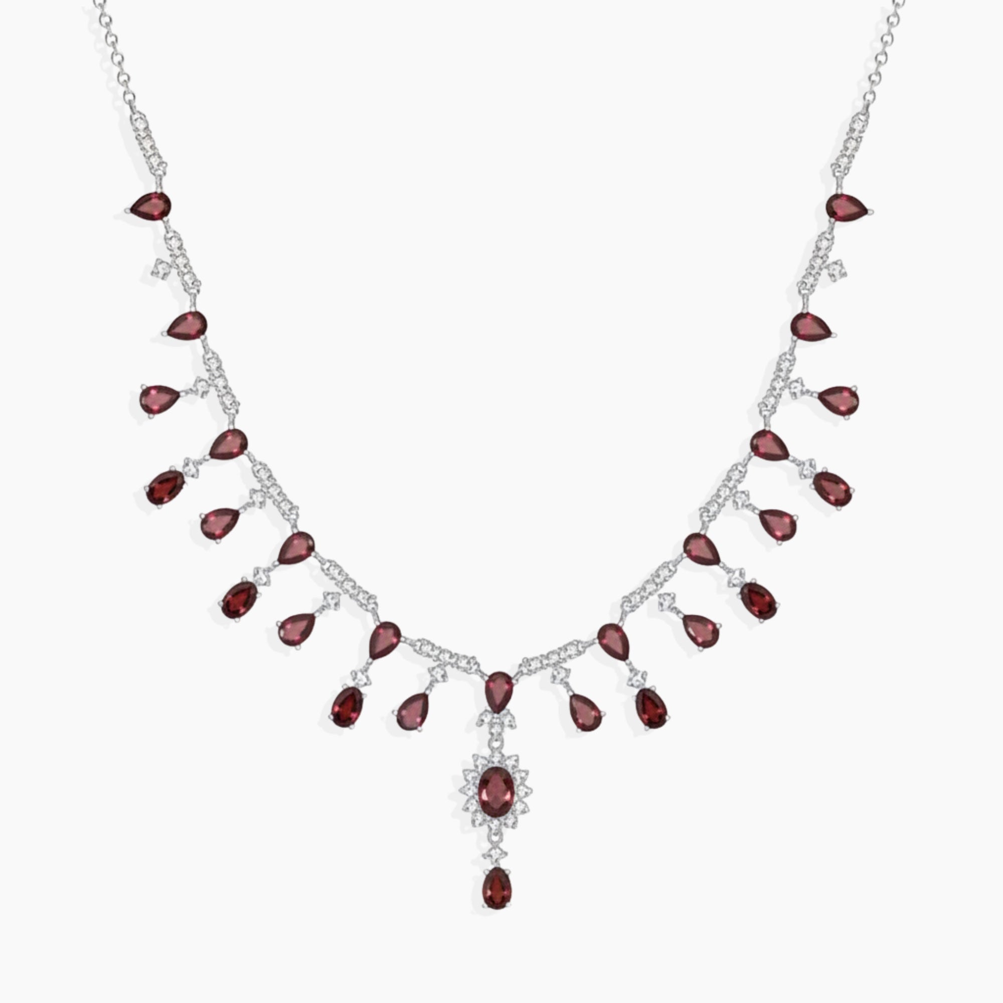 Necklace with red garnet gemstones and silver chain on a white background