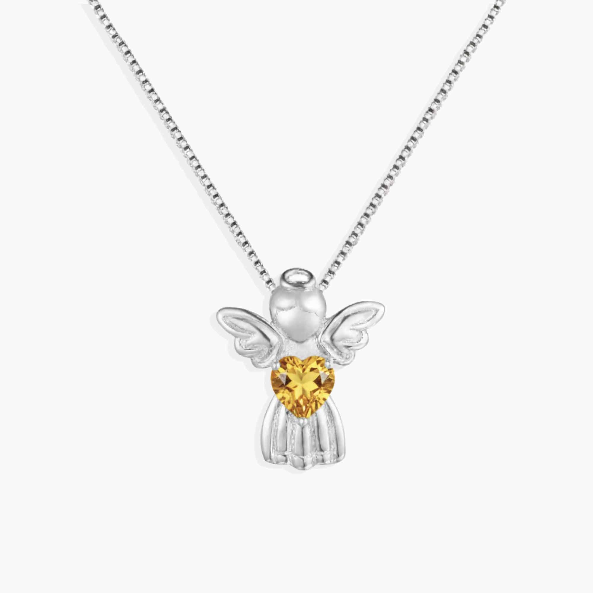 Silver angel pendant with a yellow citrine heart-shaped gem on a white background