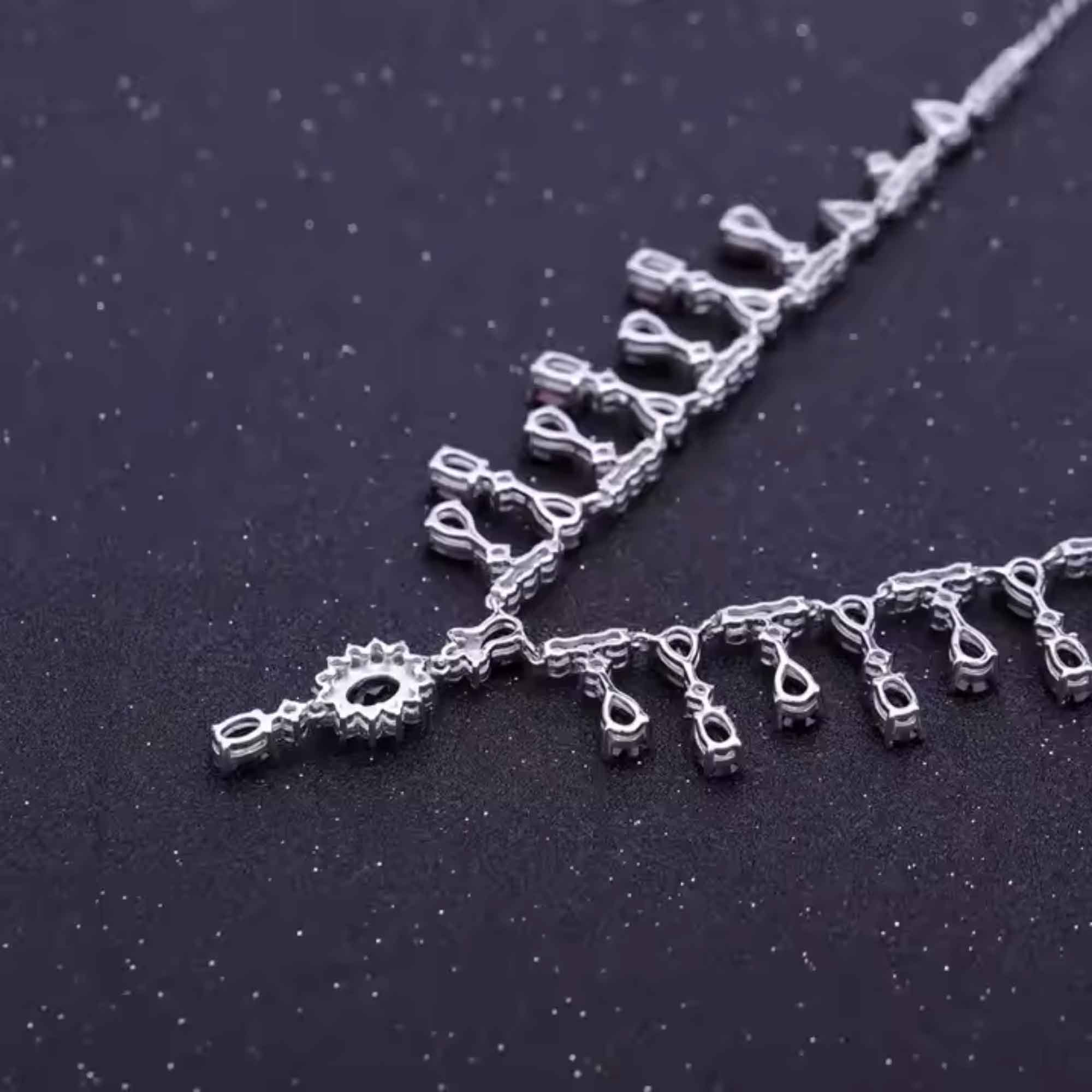 Silver necklace with decorative elements on a dark background