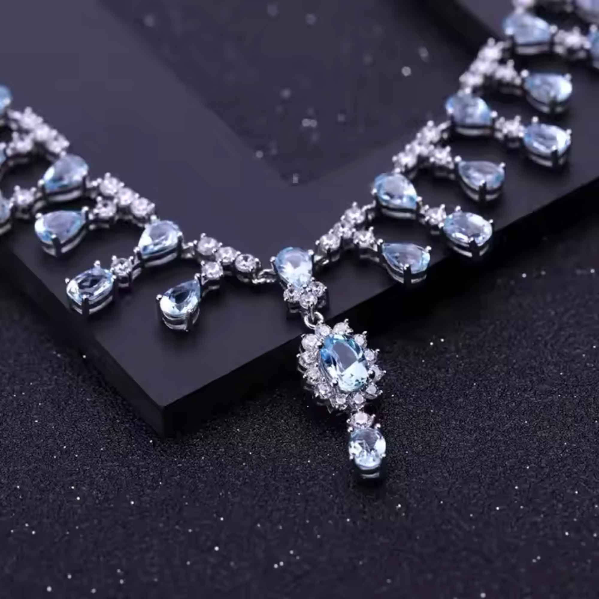Necklace with blue topaz gemstones on a dark surface