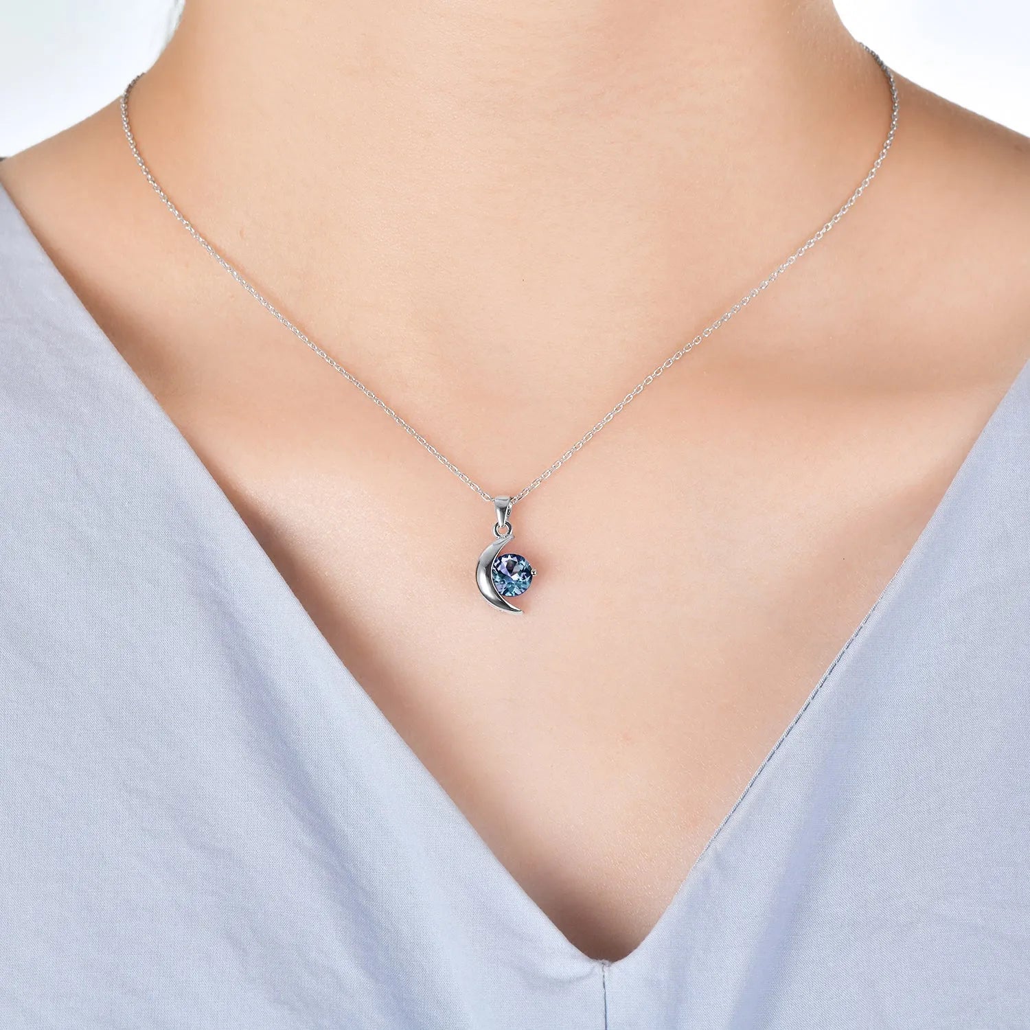 Alexandrite moon necklace worn on model – elegant silver jewellery with colour-changing gemstone