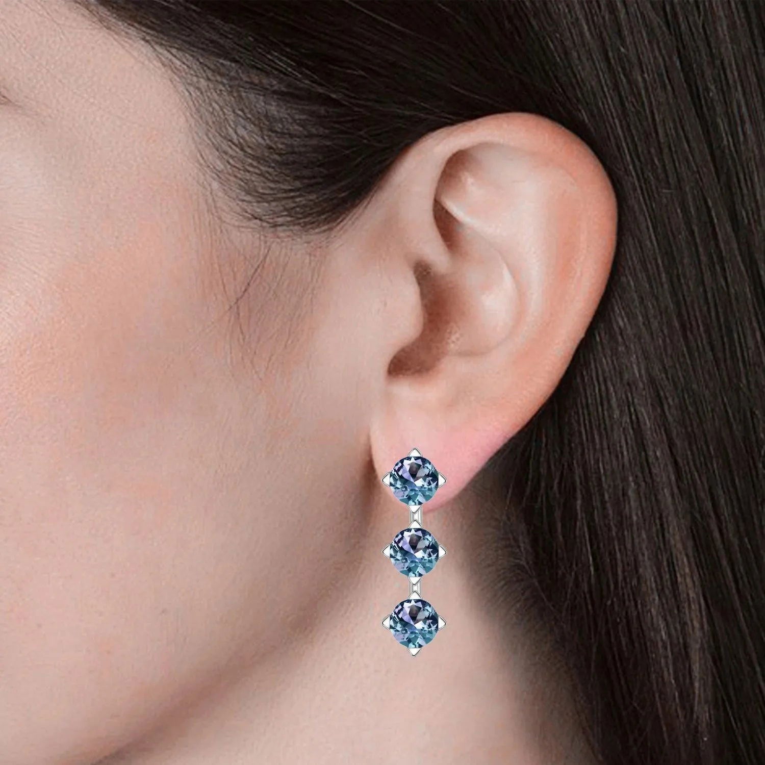 Alexandrite triple gemstone stud earrings worn on ear – elegant June birthstone jewellery for women