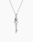 Key-shaped pendant with Alexandrite centre on rhodium-plated trace chain – meaningful jewellery design