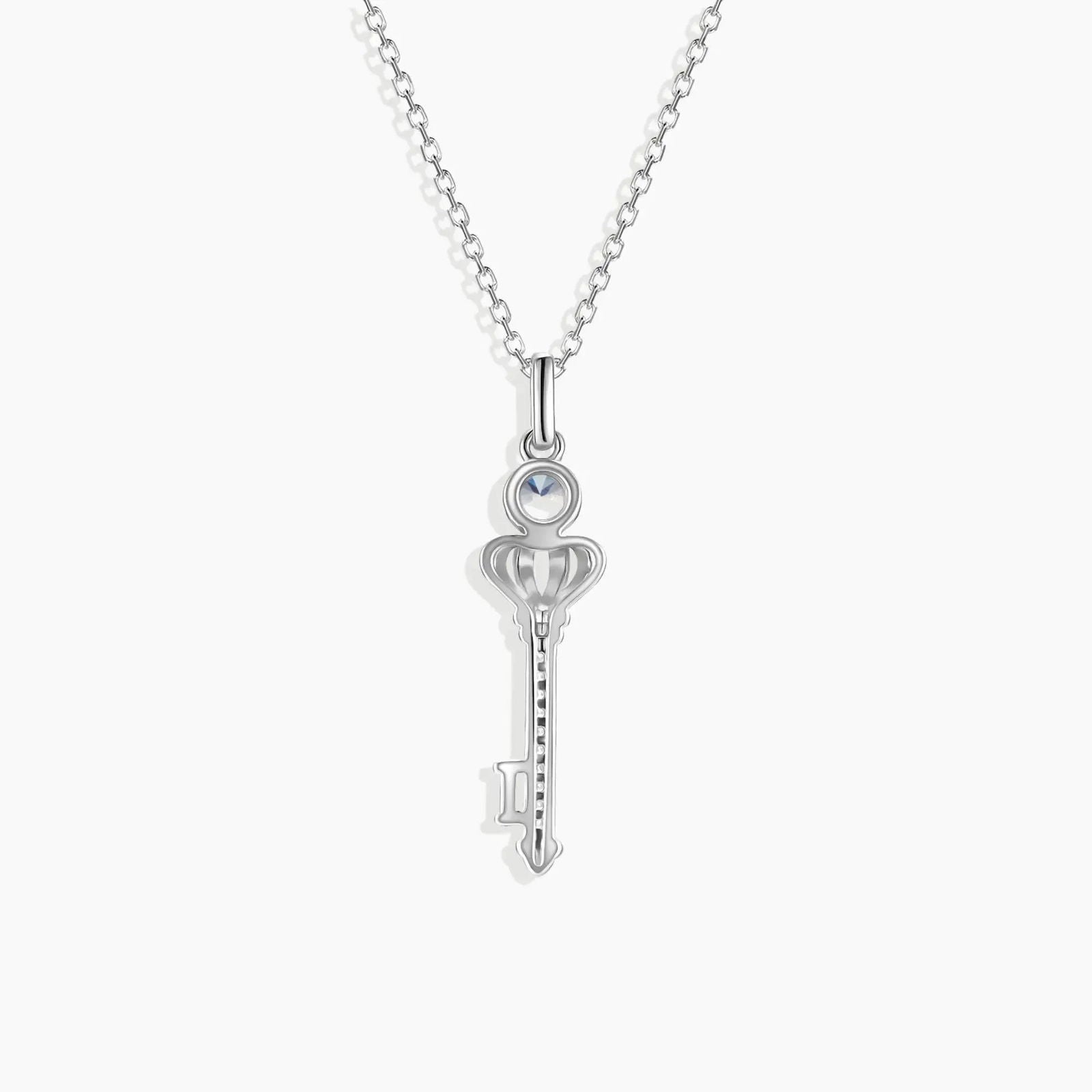 Close-up of sterling silver key pendant featuring colour-changing Alexandrite gemstone