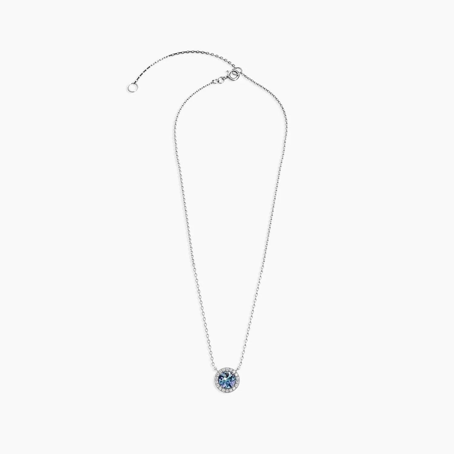 Alexandrite halo necklace laid flat with adjustable trace chain and lobster clasp