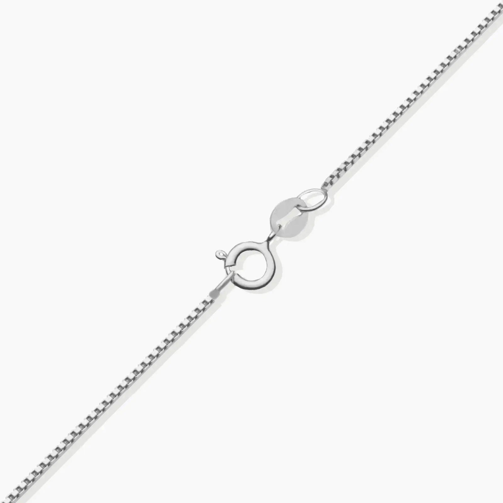 Close-up of the sterling silver chain and spring ring clasp for the emerald cross necklace.