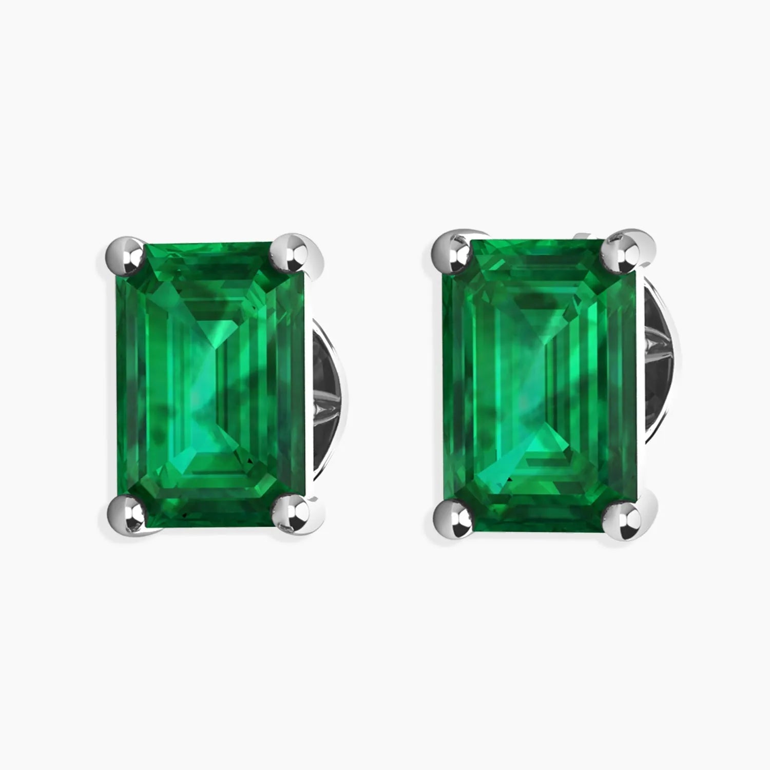 Sterling silver stud earrings featuring emerald-cut emeralds on a white background.