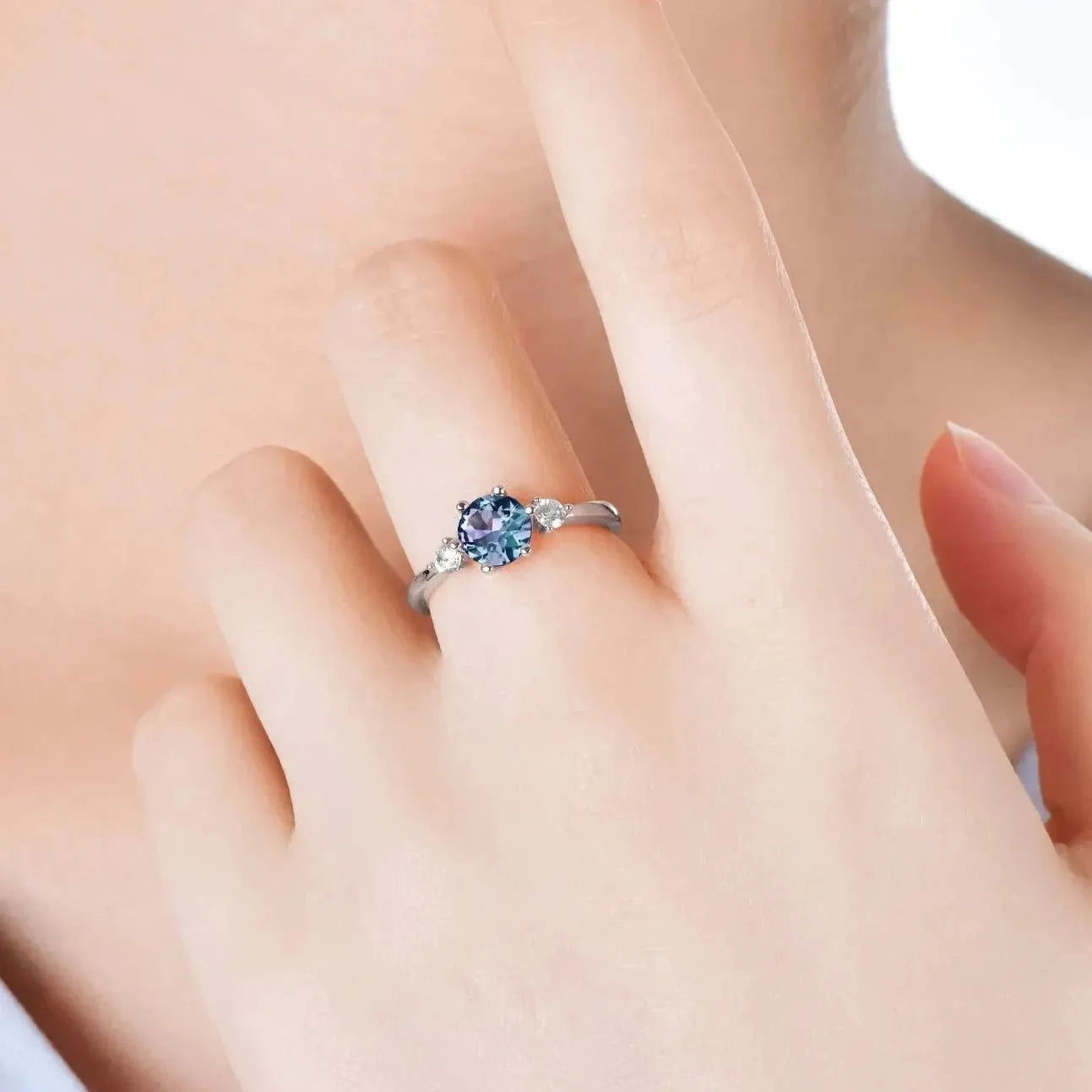 Alexandrite trilogy ring on hand – symbolic three-stone jewellery gift for women born in June