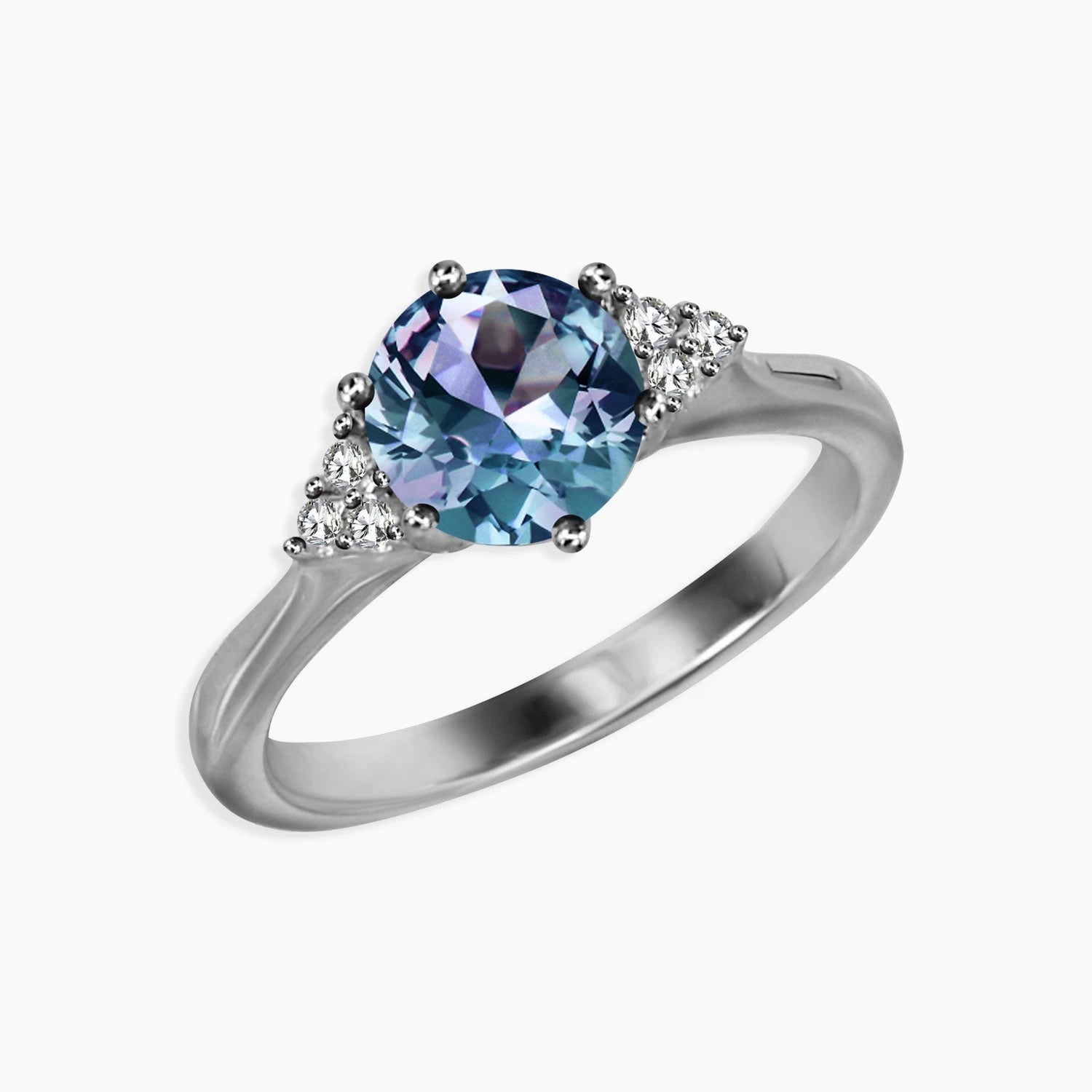 Angled side view of round Alexandrite trilogy ring with side cubic zirconia and rhodium-plated finish