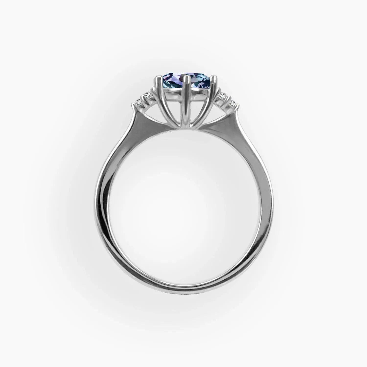 Profile view of Alexandrite trilogy ring showing prong setting and side detailing in sterling silver