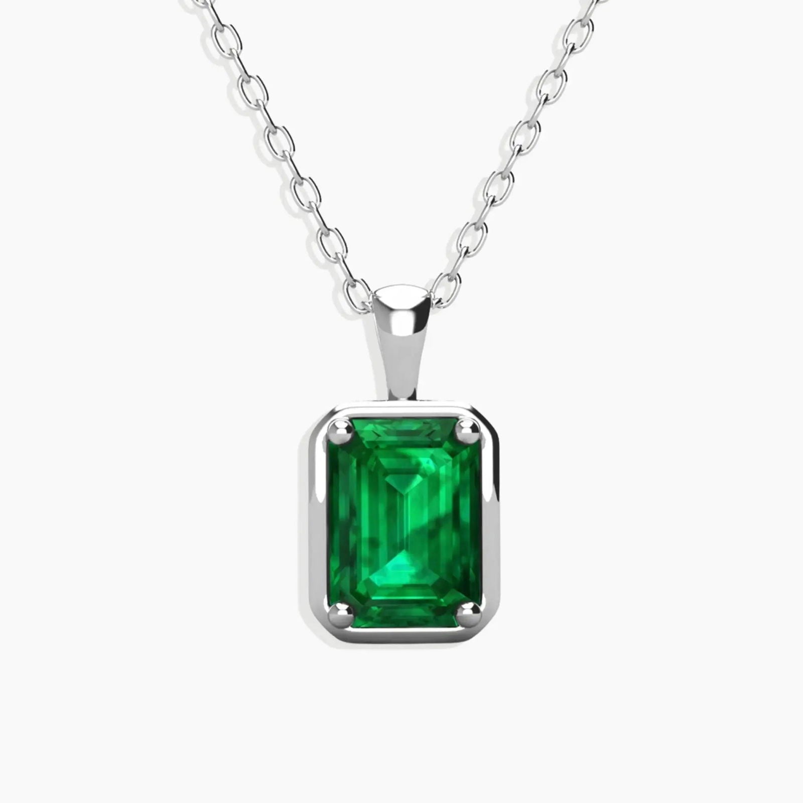 Sterling silver chain featuring a rectangular emerald-cut, lab-created emerald pendant with a vibrant green hue.