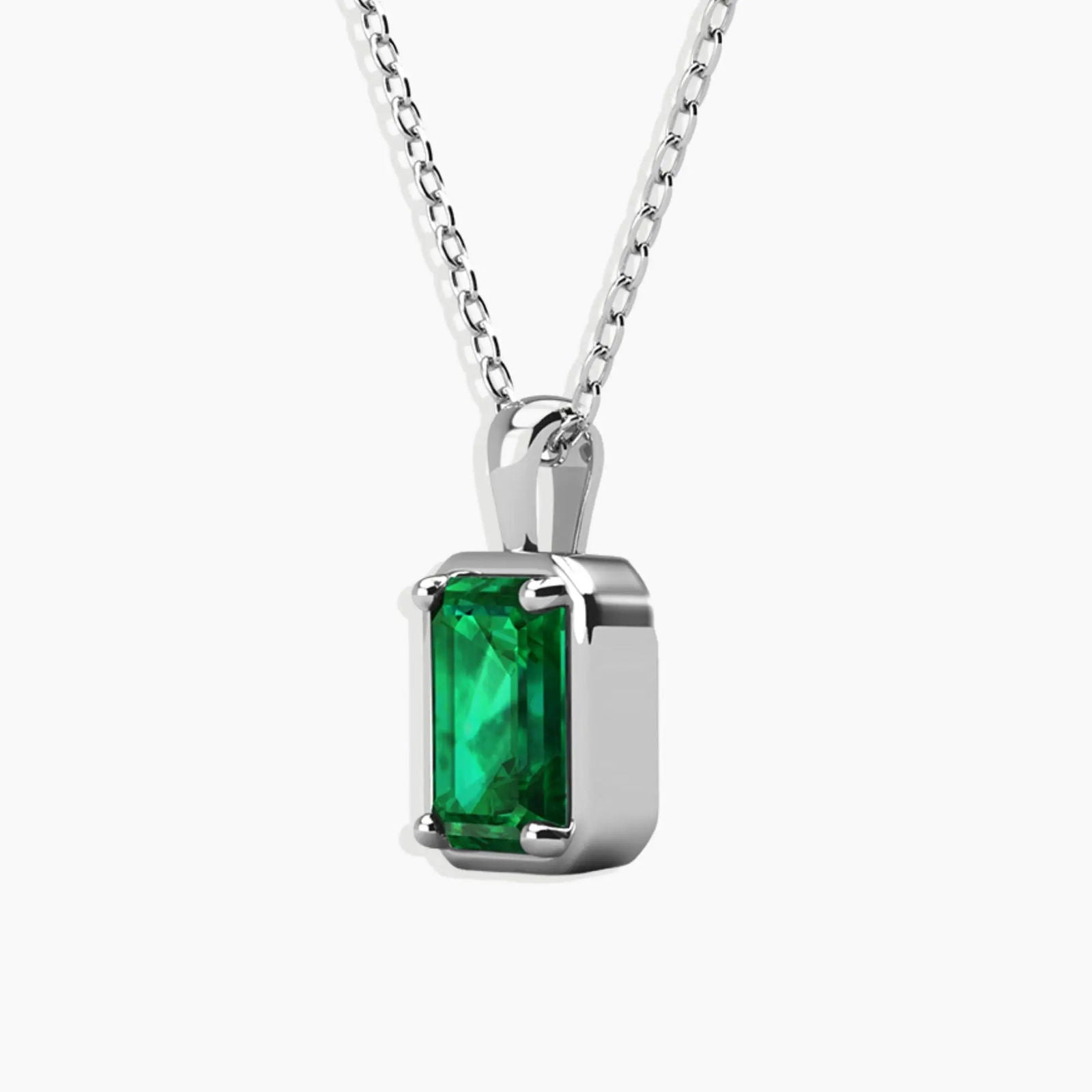 Angled close-up showing the prong setting and sparkle of the emerald-cut pendant.