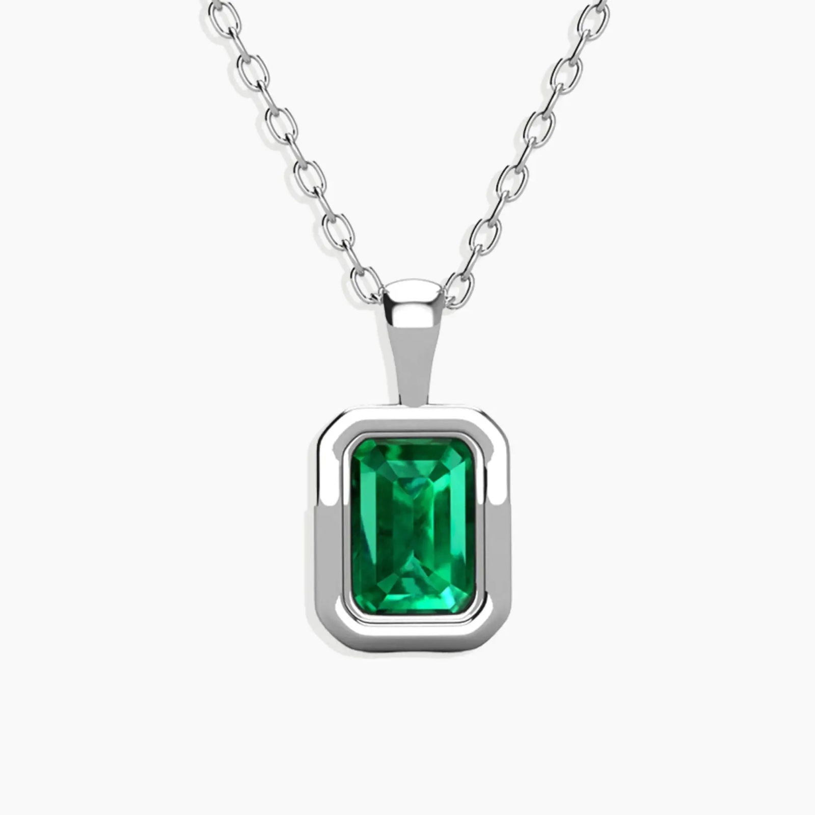 back-facing view of the emerald-cut emerald pendant on a sterling silver chain.