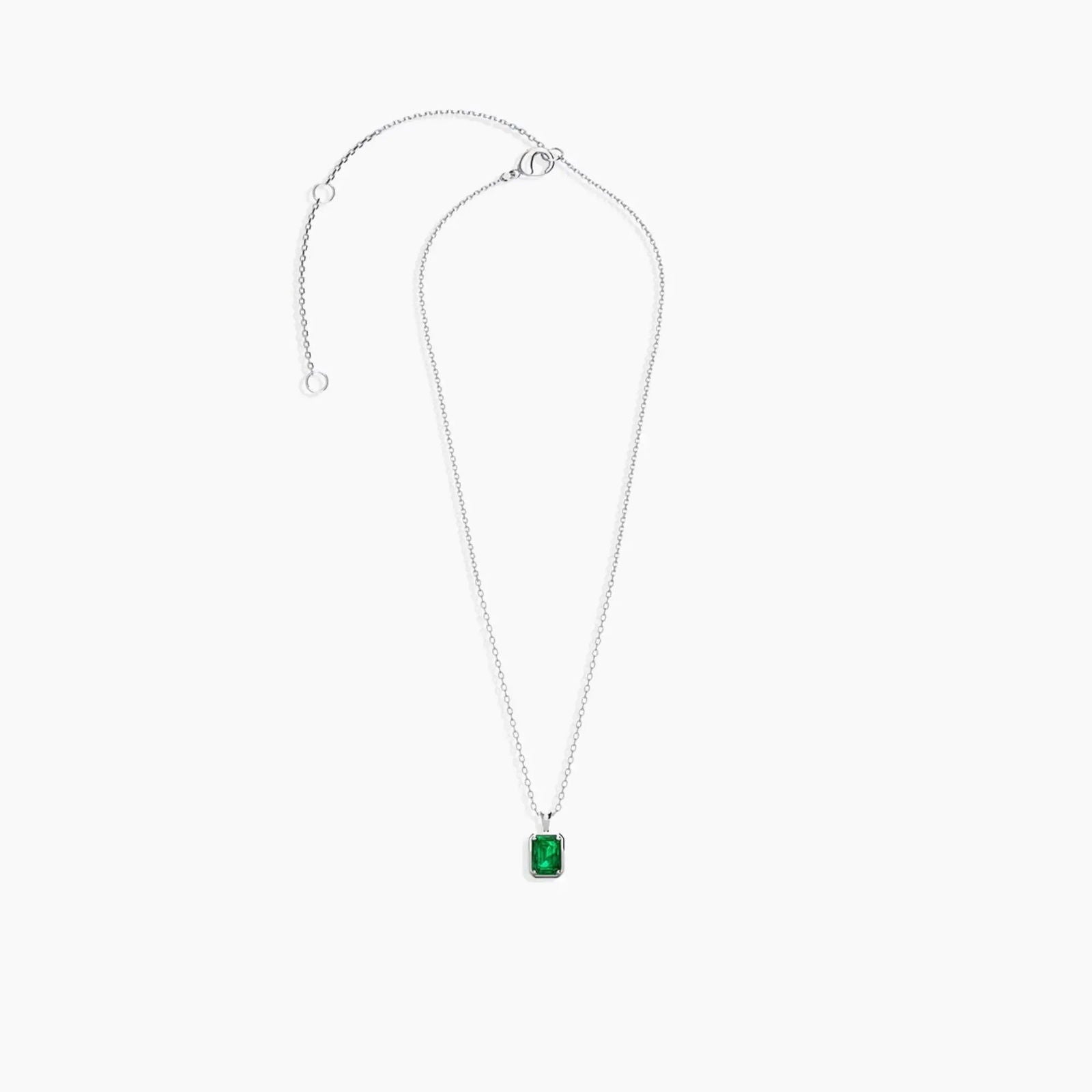 Sterling silver chain laid out with the emerald-cut pendant to display clasp and chain details.