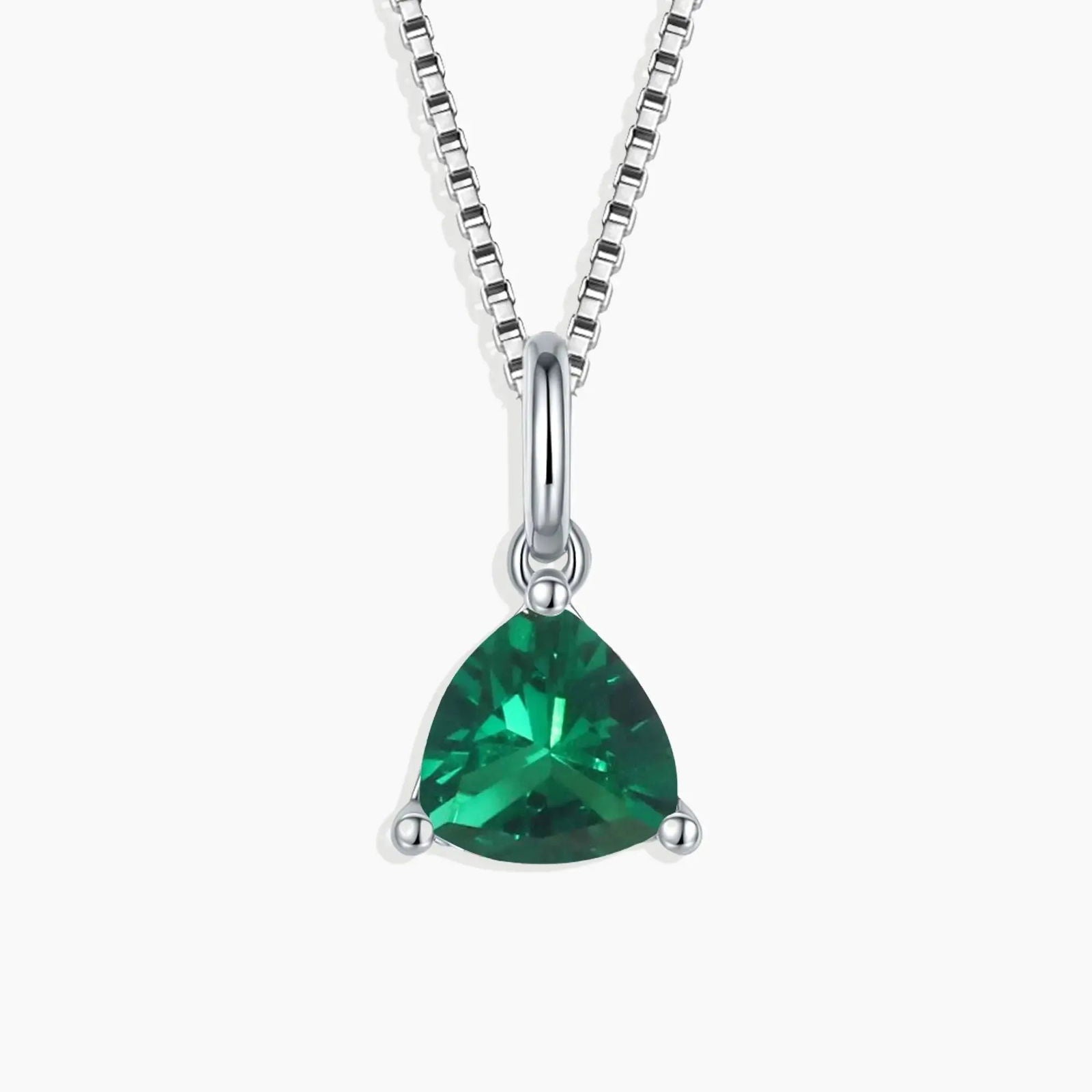 Sterling silver necklace featuring a trillion-cut emerald pendant on a white background.