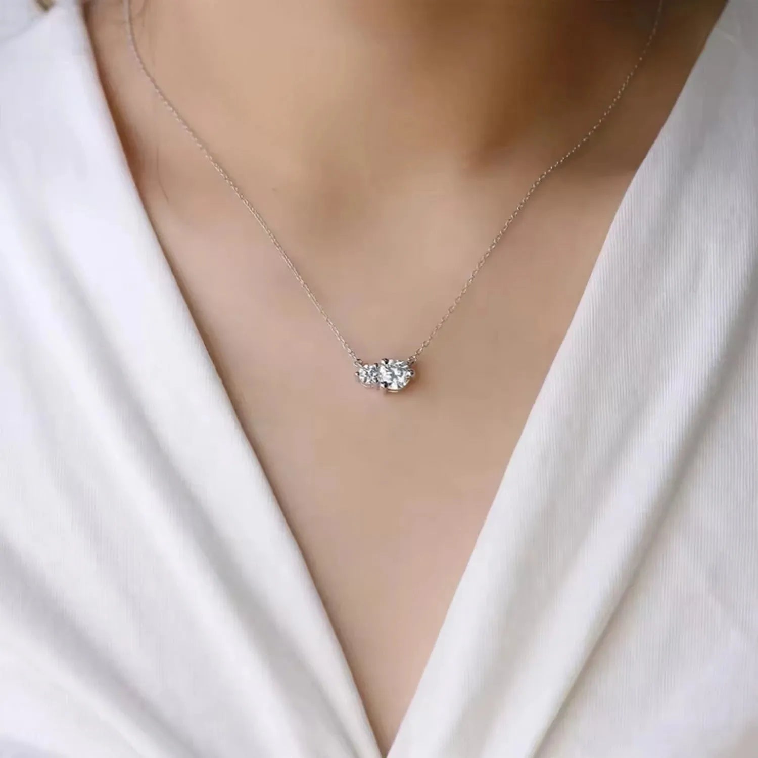 Model wearing the Moissanite Twin Pendant Necklace, showcasing its elegant twin-stone design and sparkling moissanite gems.