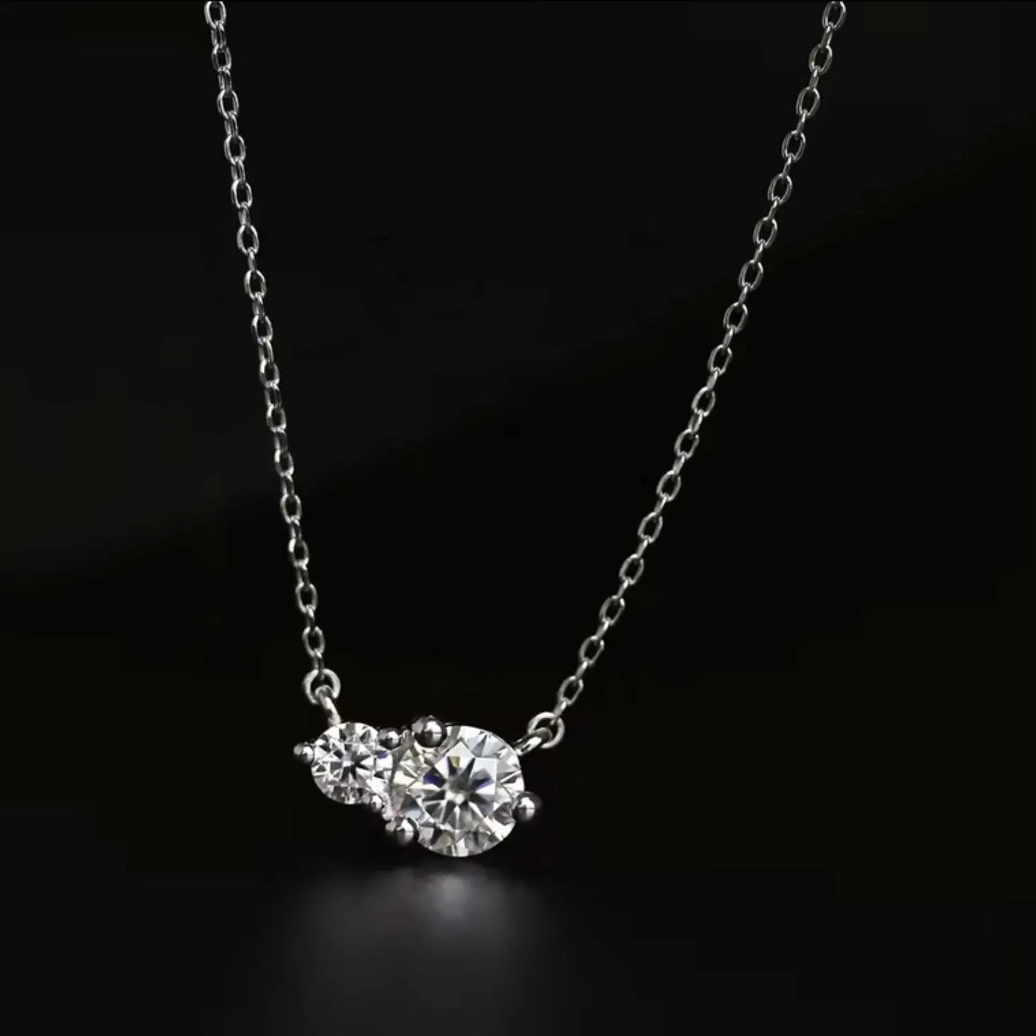 Moissanite Twin Pendant Necklace against a black backdrop, emphasizing the radiant shine of its lab-grown gemstones.