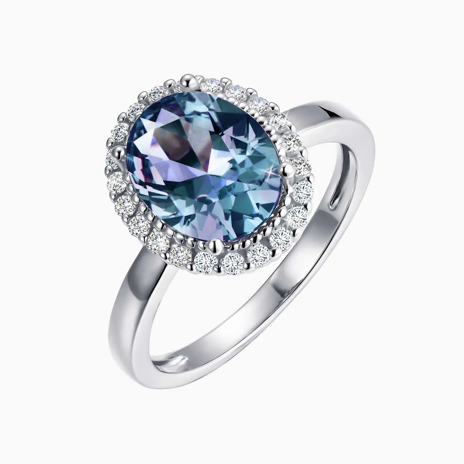 Alexandrite halo ring with colour-changing gemstone and CZ border on dark background – sterling silver
