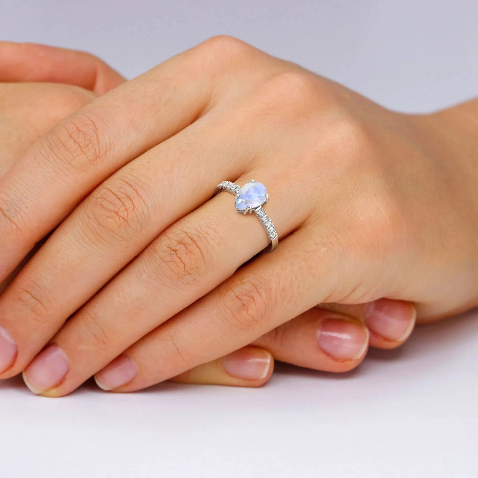 Pear-shaped moonstone ring worn on hand – dainty June birthstone jewellery