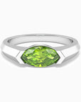 A marquise-cut peridot gemstone ring in silver, with a semi-bezel setting and a rhodium-plated band.