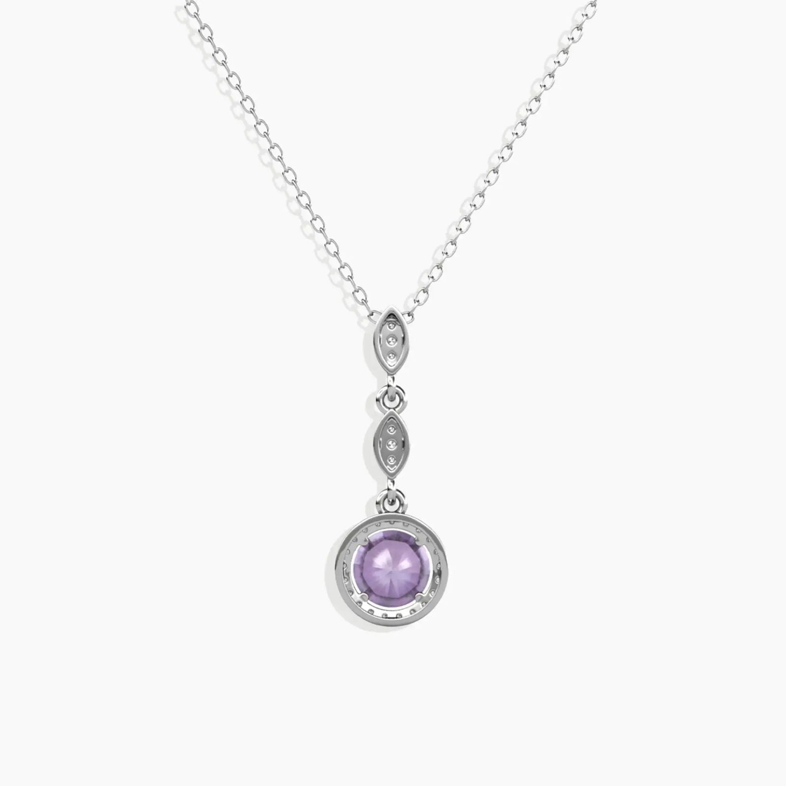 Alexandrite pendant showing gemstone’s transition from blue to purple under different lighting