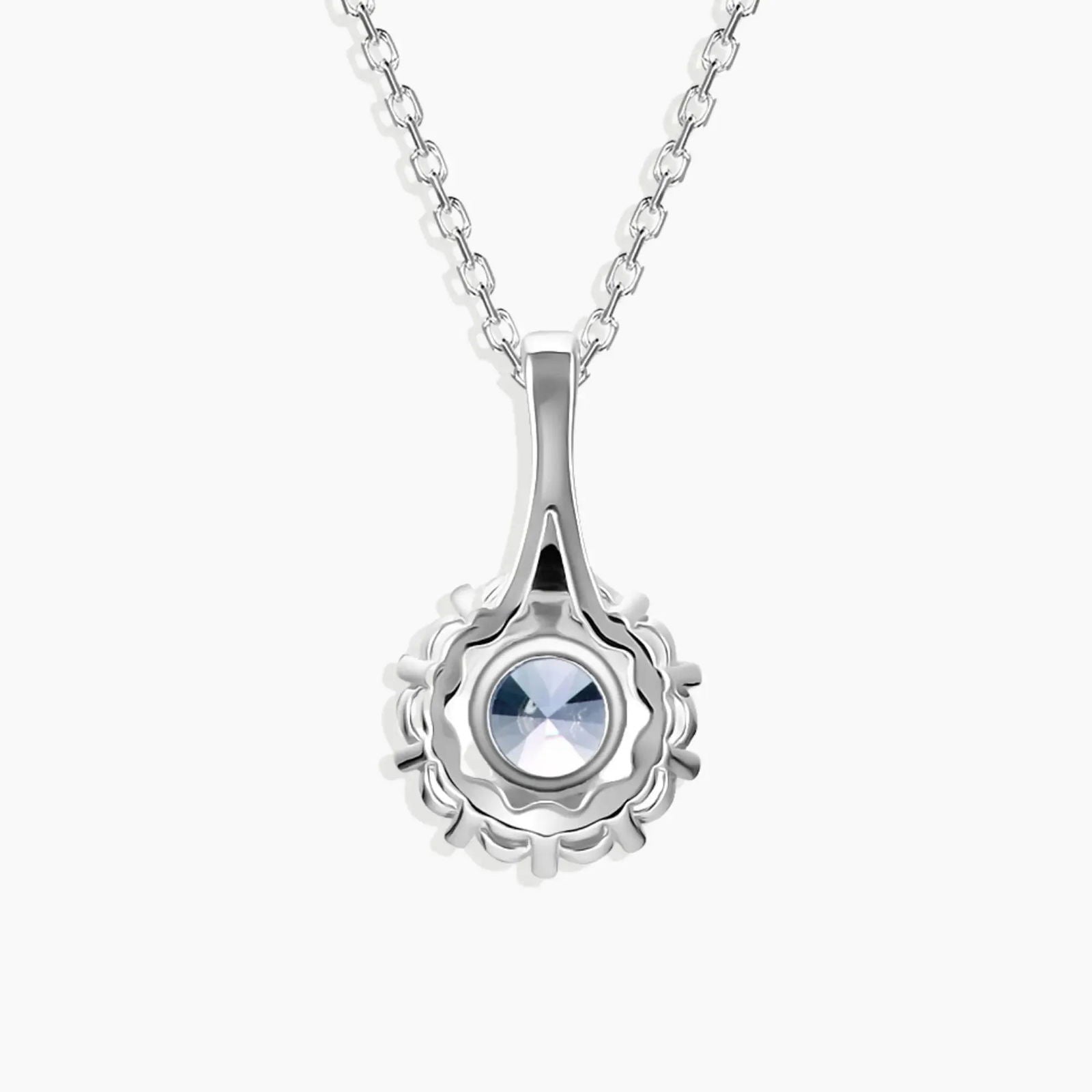Close-up view of Alexandrite pendant with halo setting and brilliant light reflection