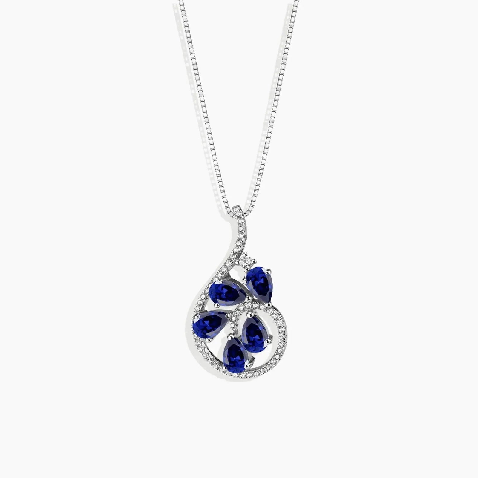 Teardrop-shaped sapphire pendant necklace in sterling silver featuring blue gemstones arranged in a floral pattern, perfect for adding elegance to any outfit.