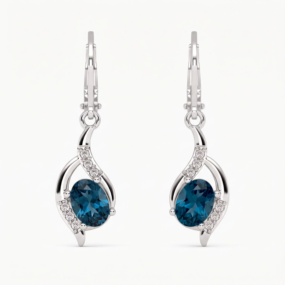 Pair of London blue topaz oval drop earrings in sterling silver with curved accent frame and leverbacks