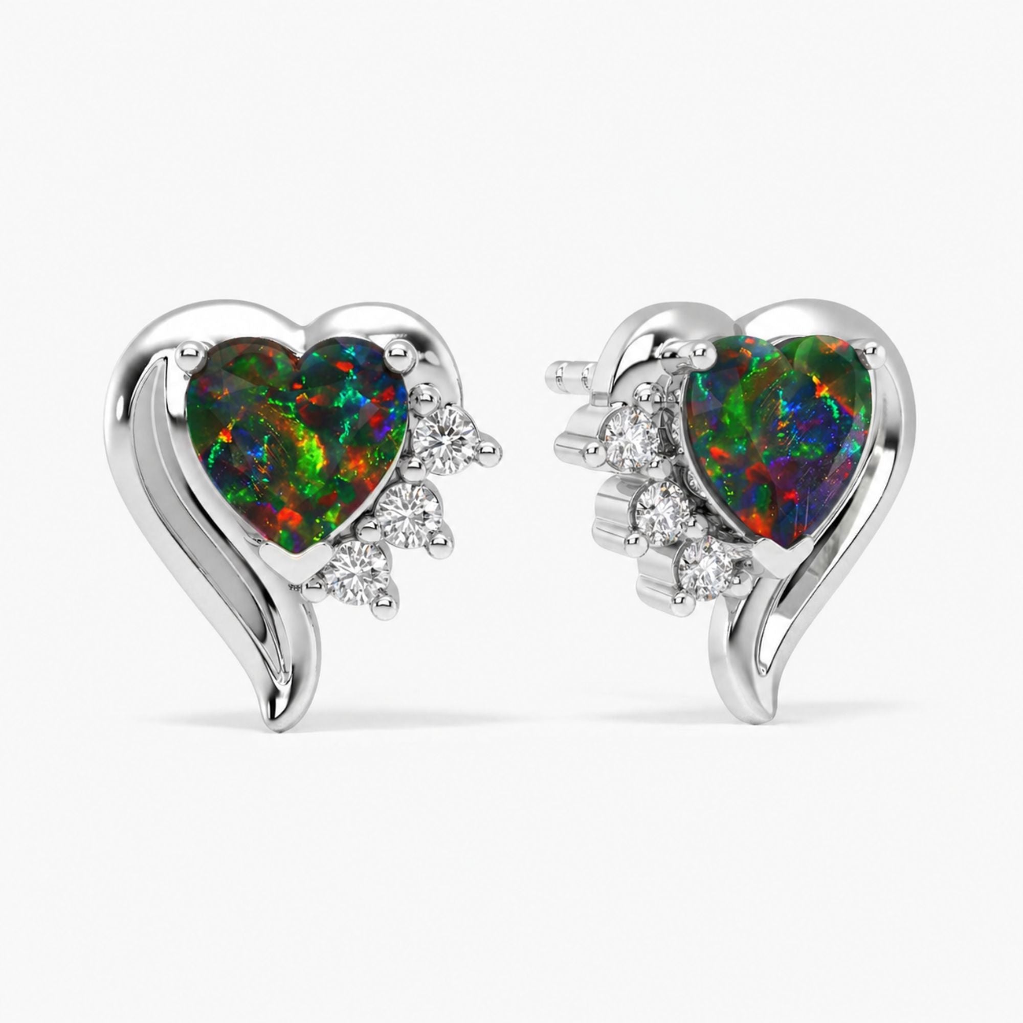 Heart-shaped opal earrings with diamond accents on a white background