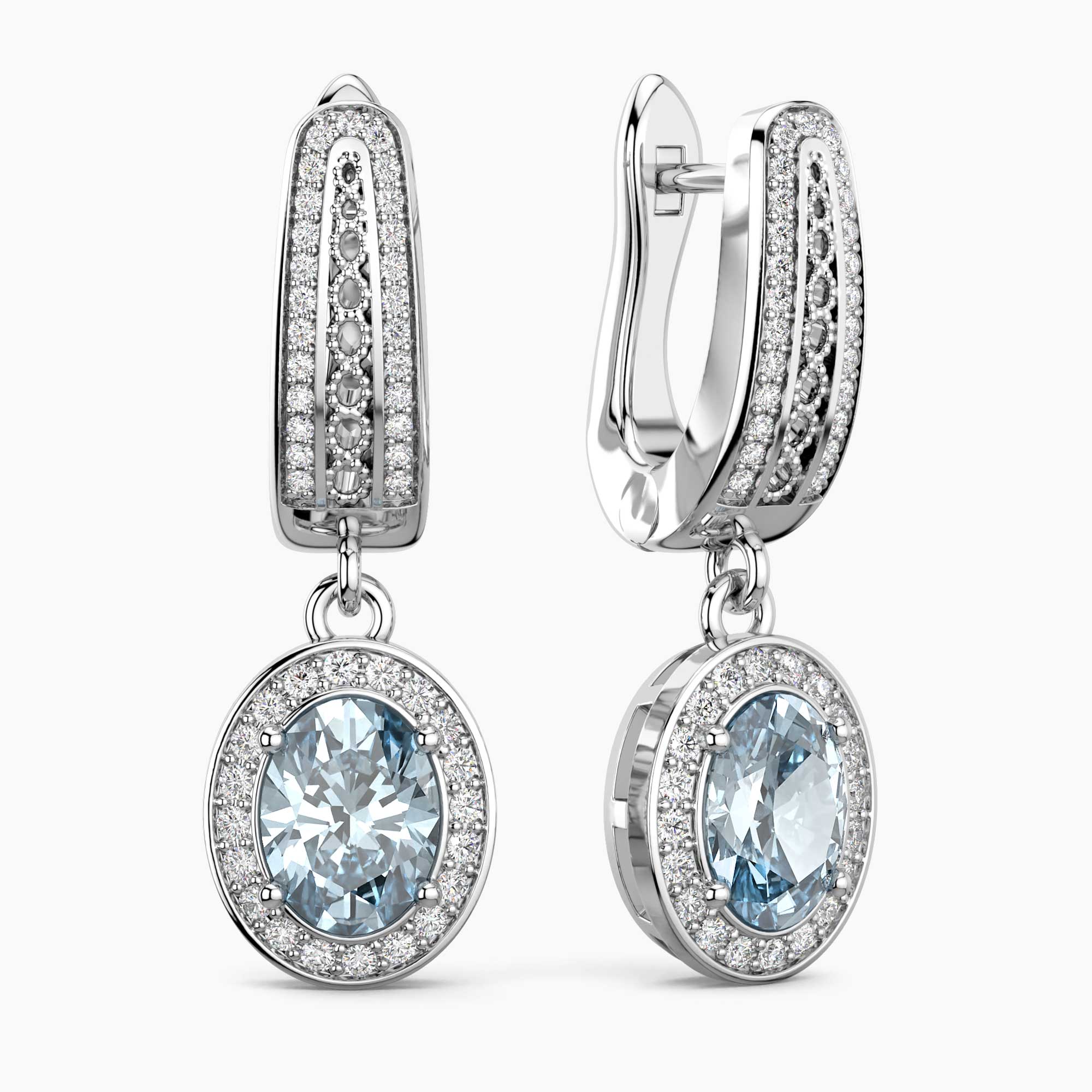 Pair of silver earrings with aquamarine gemstones on a white background