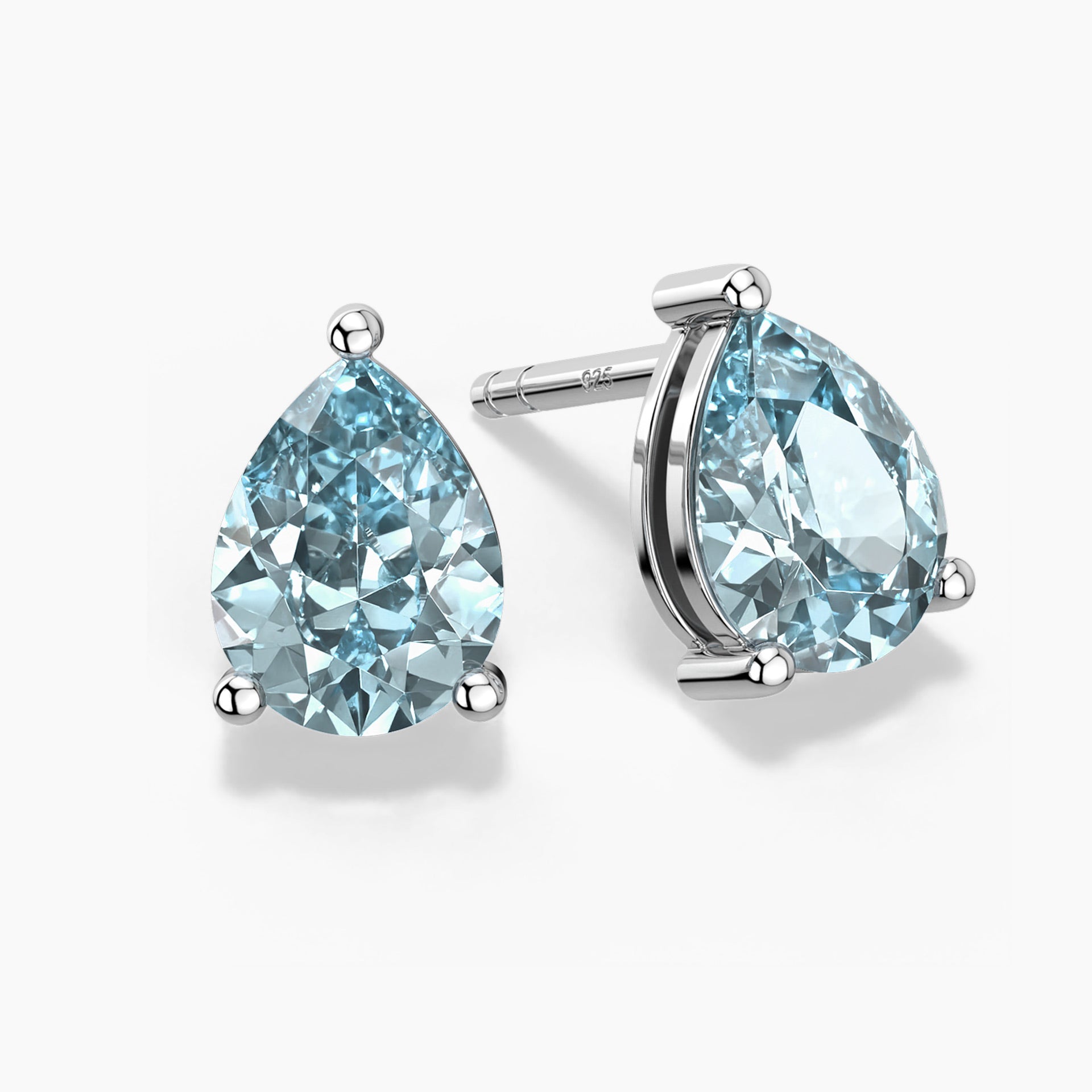 Teardrop-shaped aquamarine stud earrings in silver claw setting