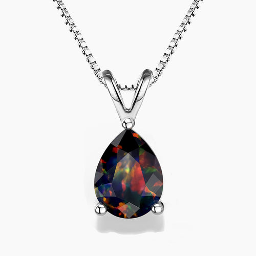 A pear-shaped black opal pendant showcasing vibrant play-of-color flashes of red, green, and orange, set in a three-prong polished sterling silver V-shaped bail, hanging from a delicate silver box chain on a white background.