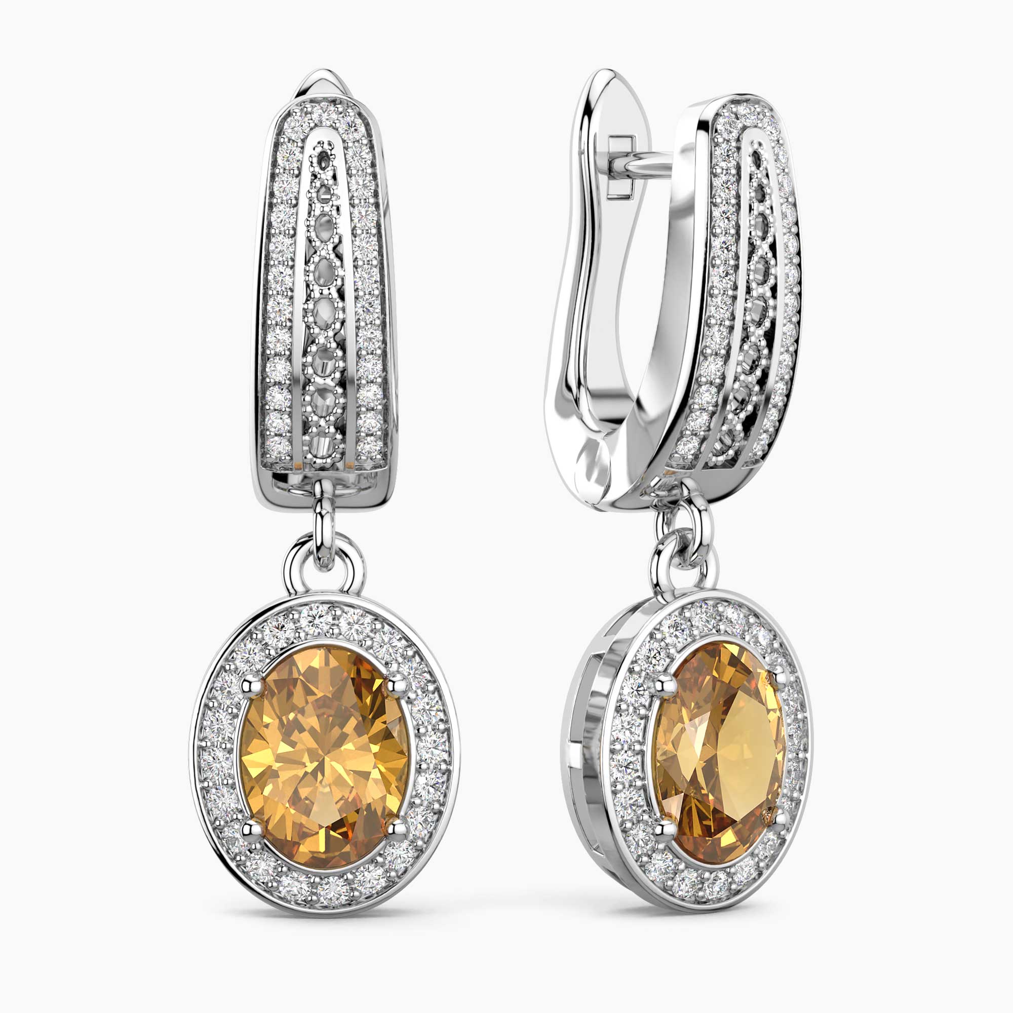 Pair of silver earrings with yellow citrine gemstones on a white background