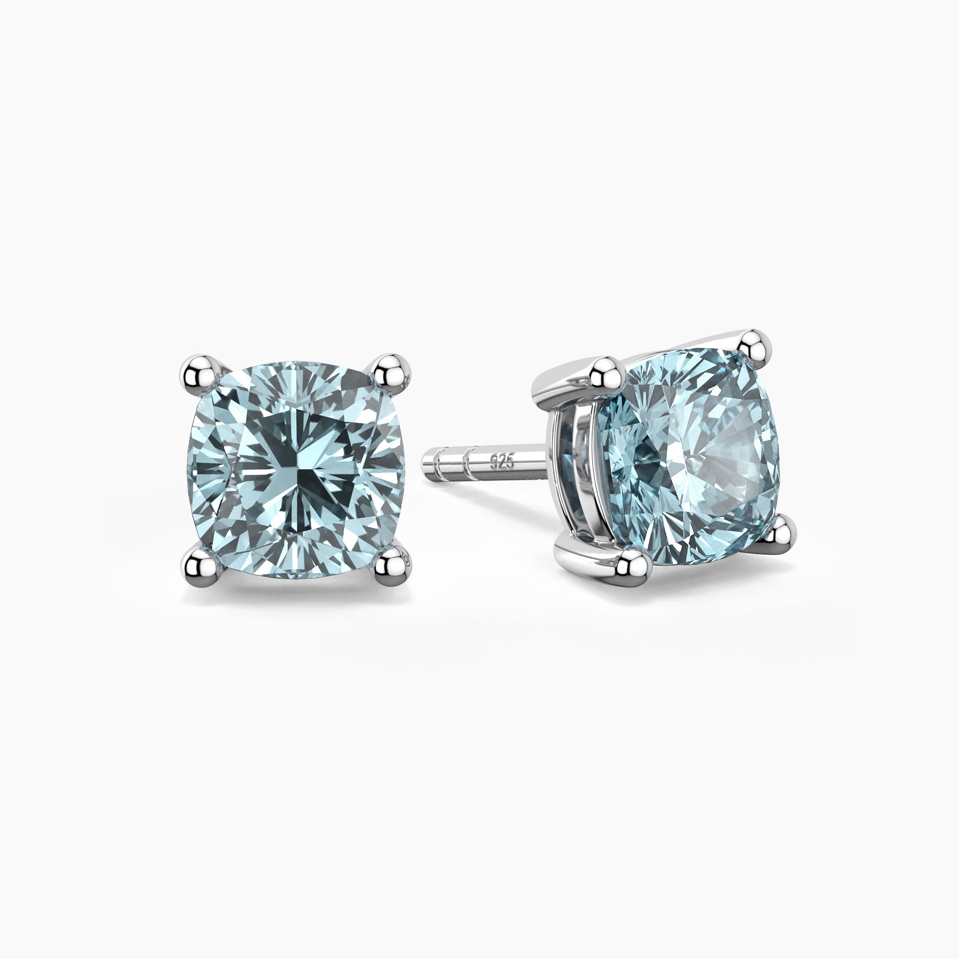 Cushion-cut aquamarine stud earrings in sterling silver, featuring soft blue gemstones set in elegant four-prong mountings.
