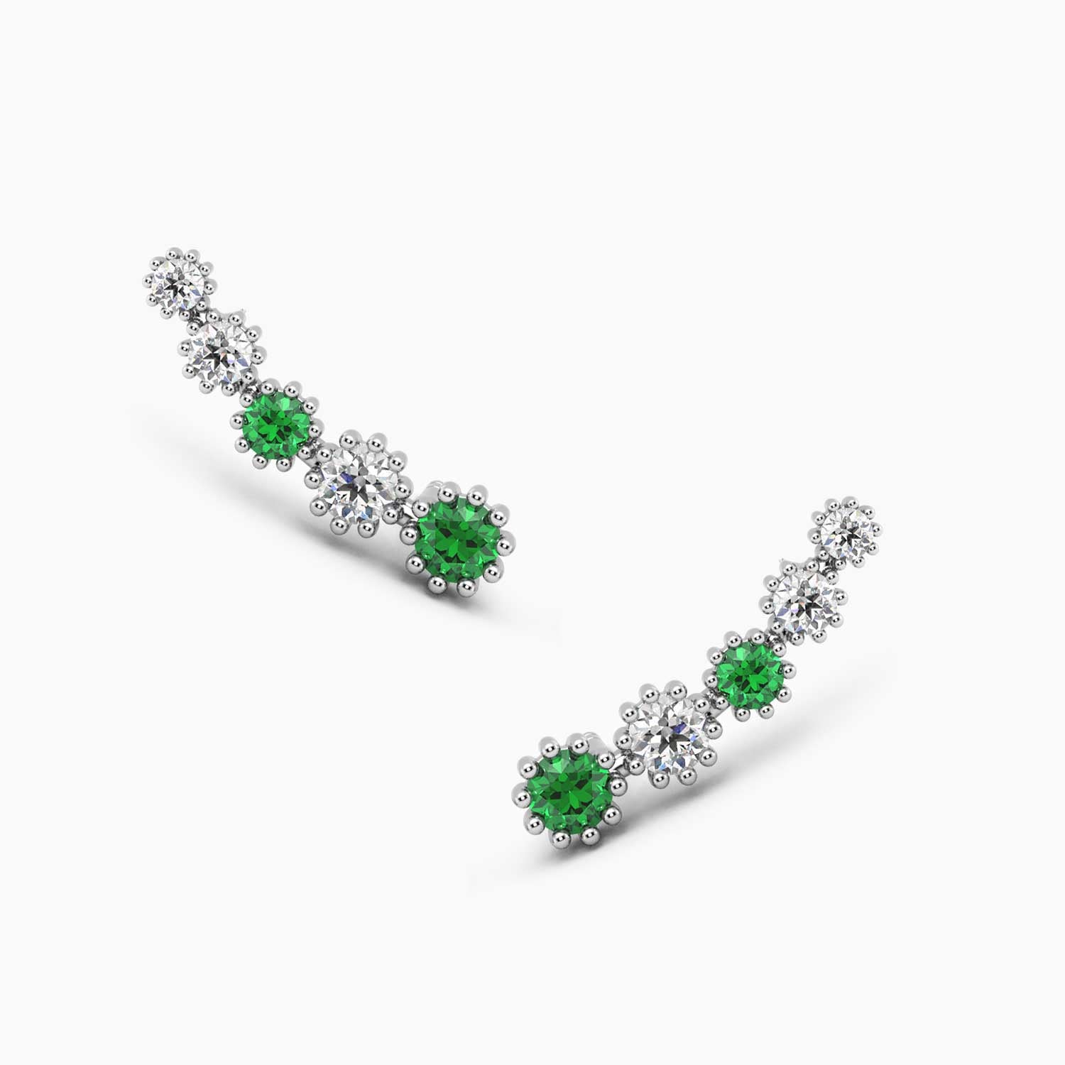 Sterling silver climber earrings featuring round emeralds and diamond stimulants in a floral design.
