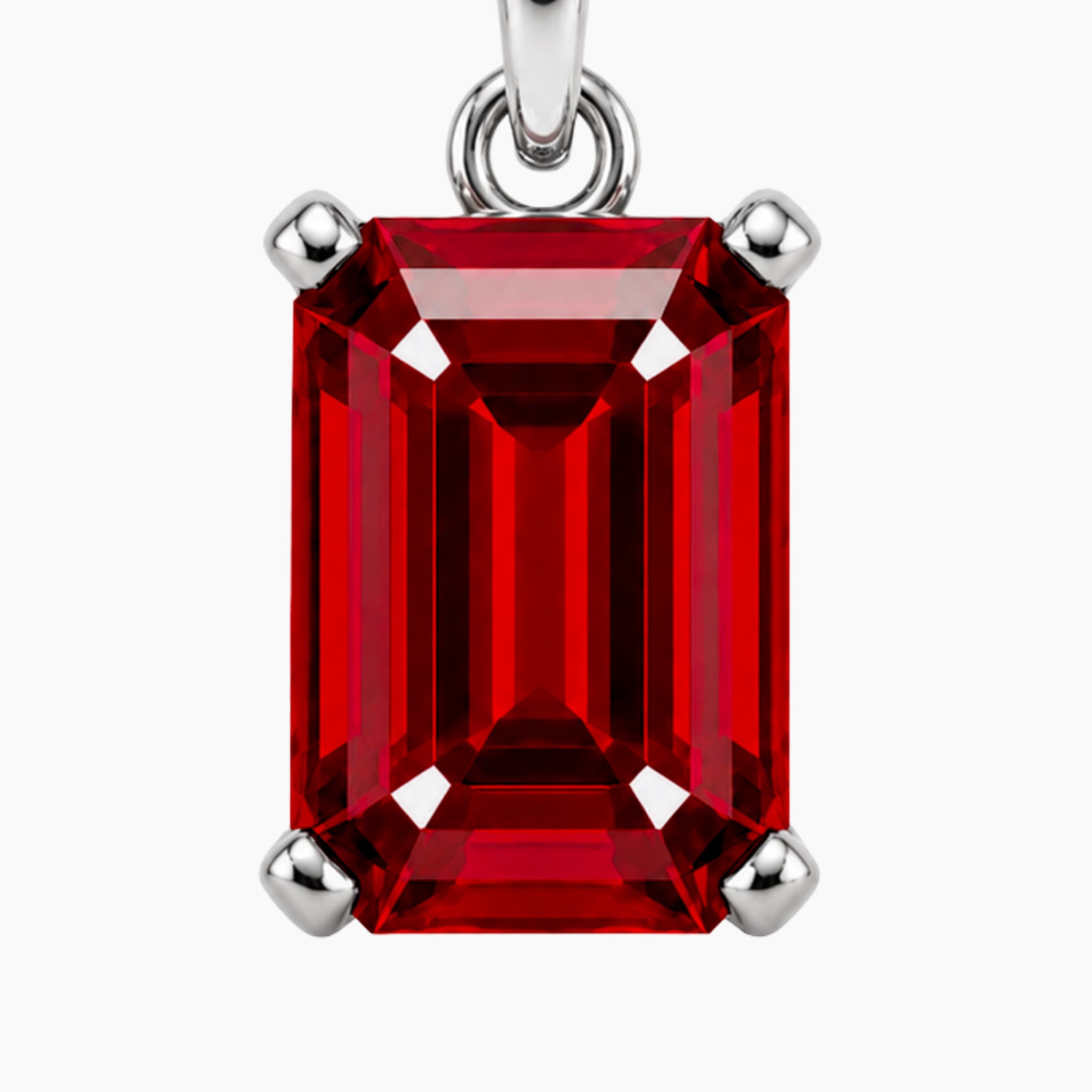 Red ruby gemstone pendant macro emerald cut with silver setting on a white background