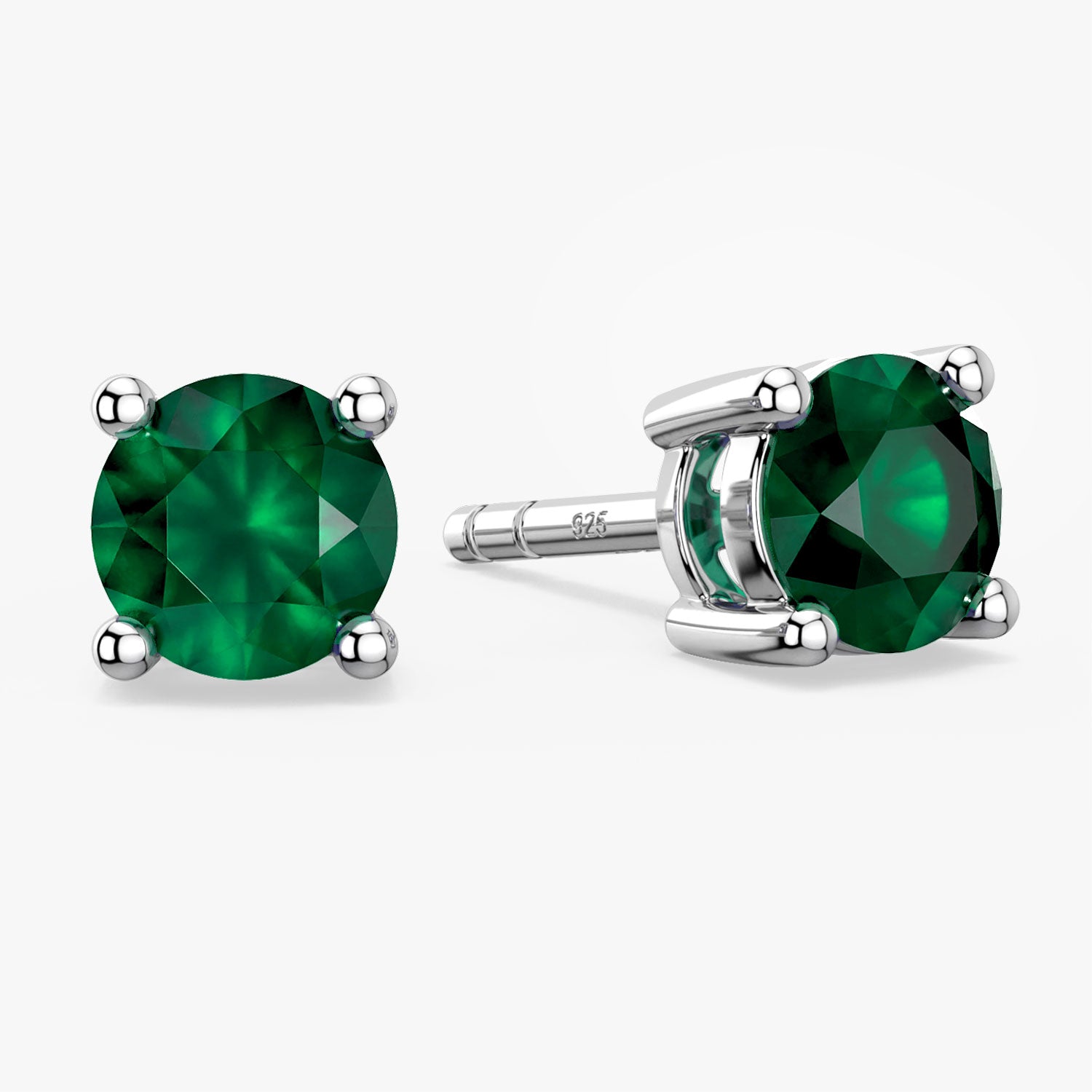 emerald round stud earrings on white background