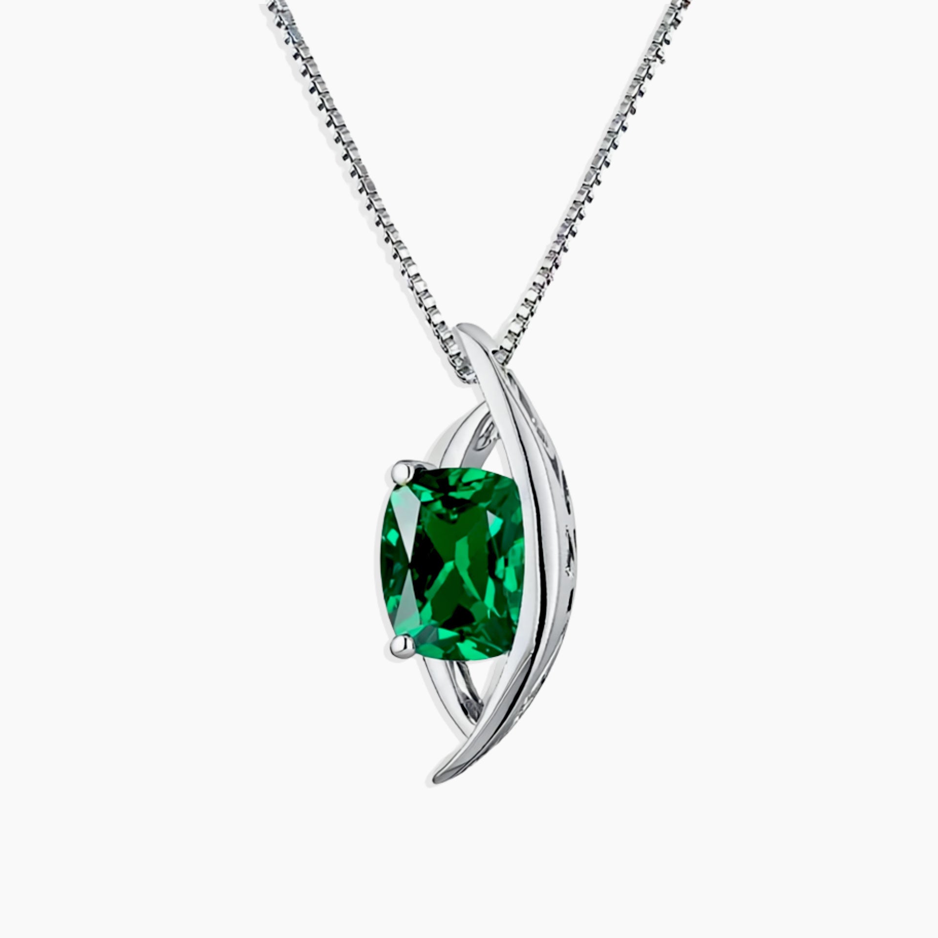 Silver pendant with a green gemstone on a white background
