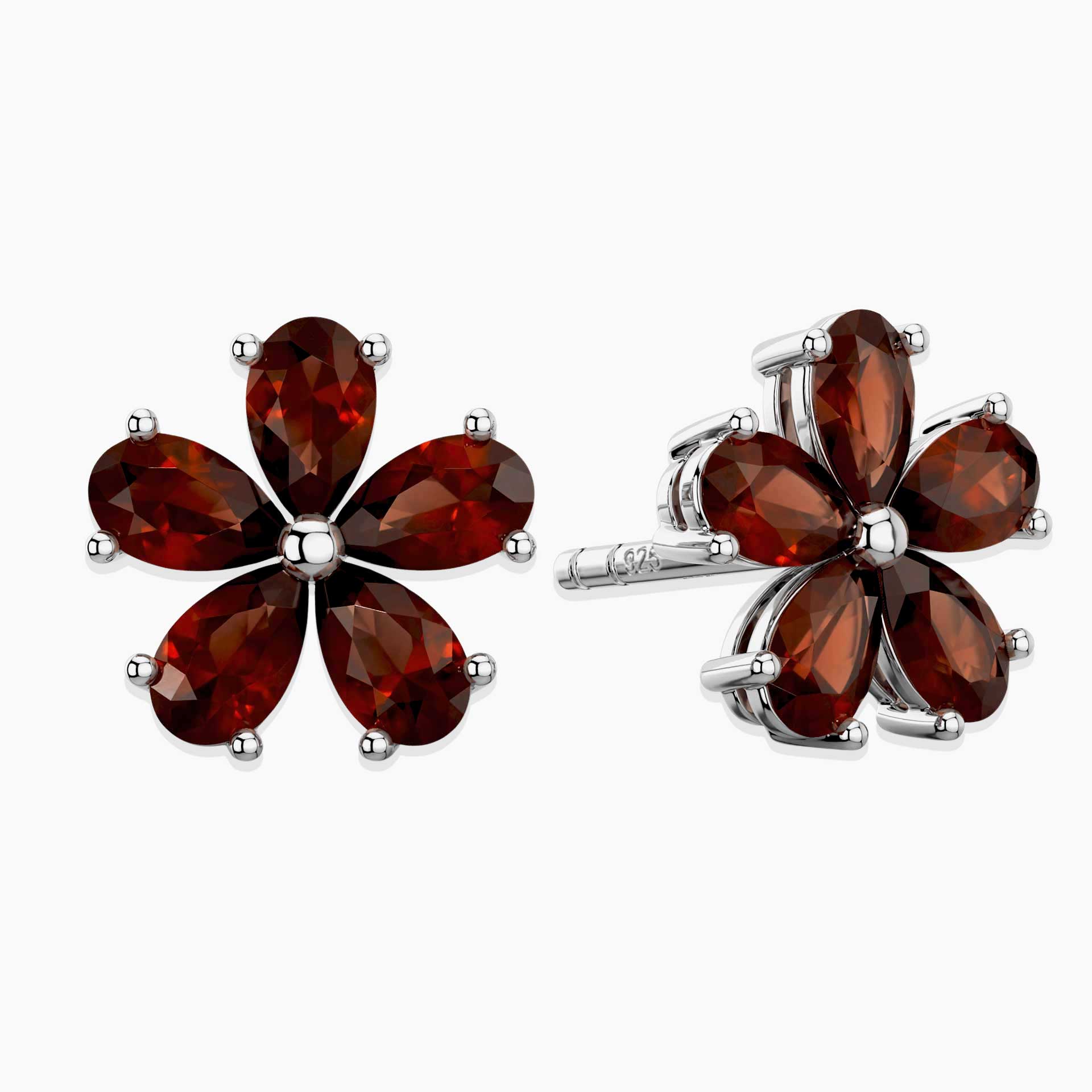 Flower-shaped earrings with red garnet gemstones on a white background