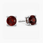 Pair of red garnet gemstone stud earrings on a white background