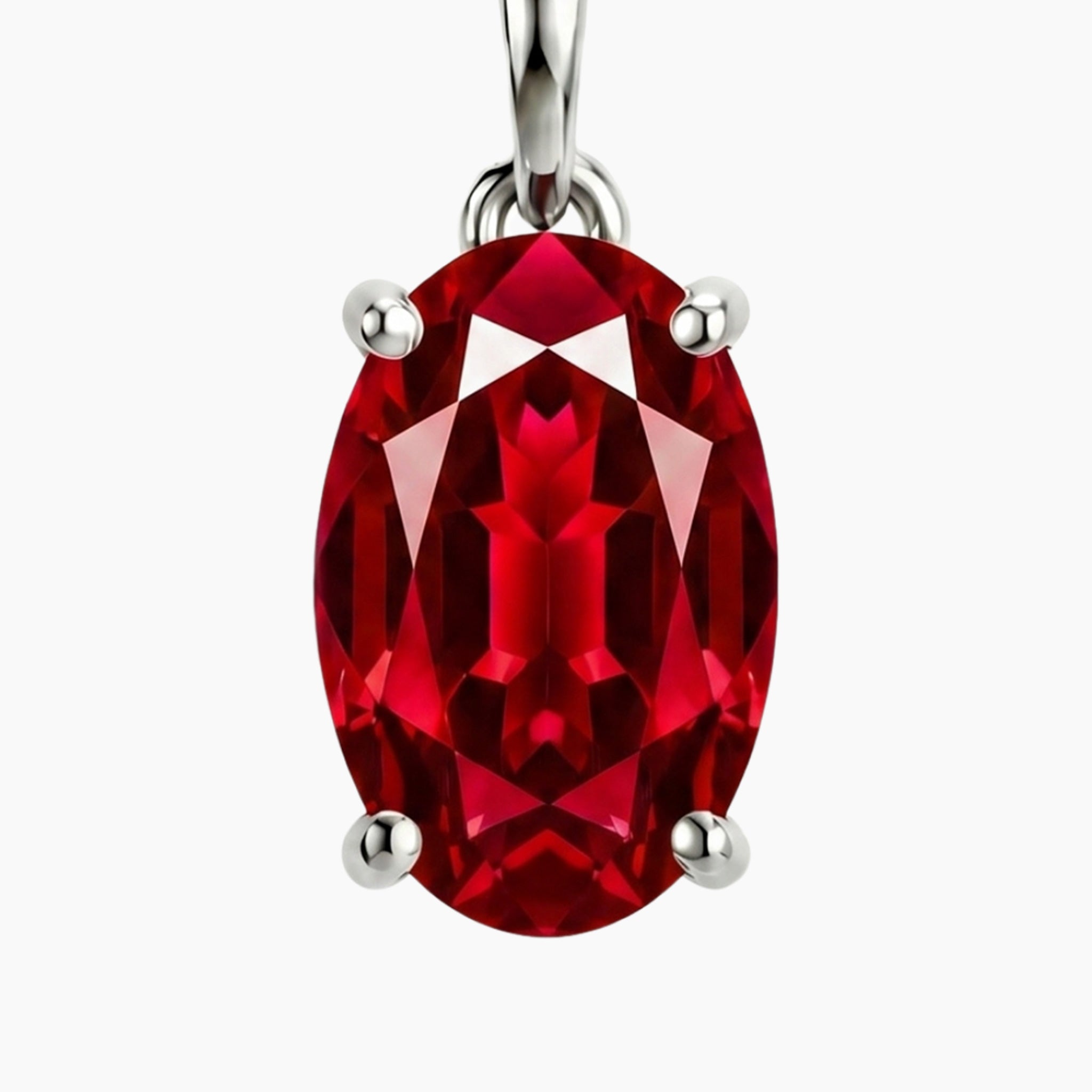 Red oval ruby gemstone pendant with silver setting on a white background