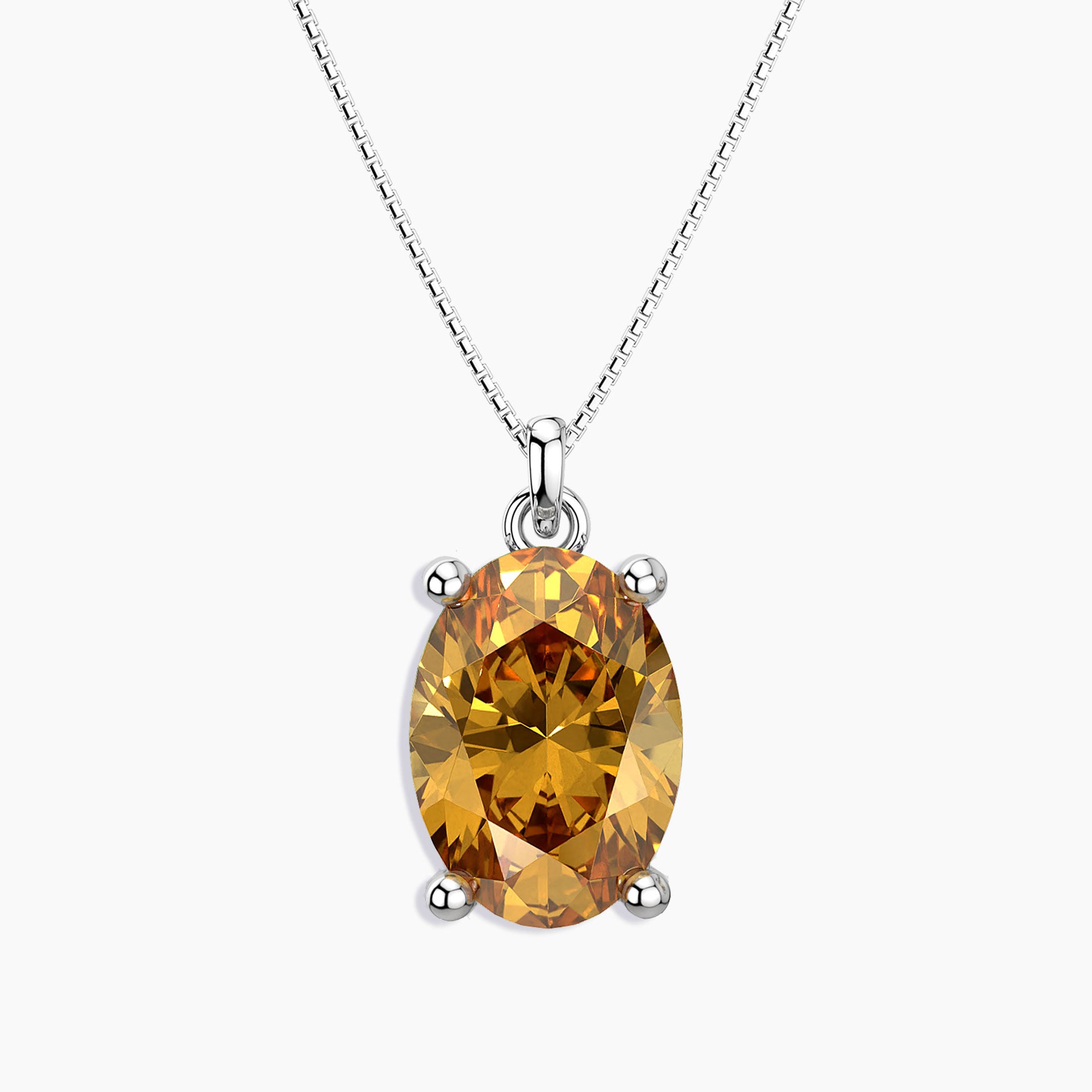 Oval-cut golden yellow citrine pendant in a four-prong silver setting, hanging from a polished silver box chain, displayed on a white background.