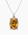 Oval-cut golden yellow citrine pendant in a four-prong silver setting, hanging from a polished silver box chain, displayed on a white background.
