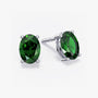 Pair of oval-cut deep green gemstone stud earrings in a four-prong silver setting with push-back closures, displayed on a white background.