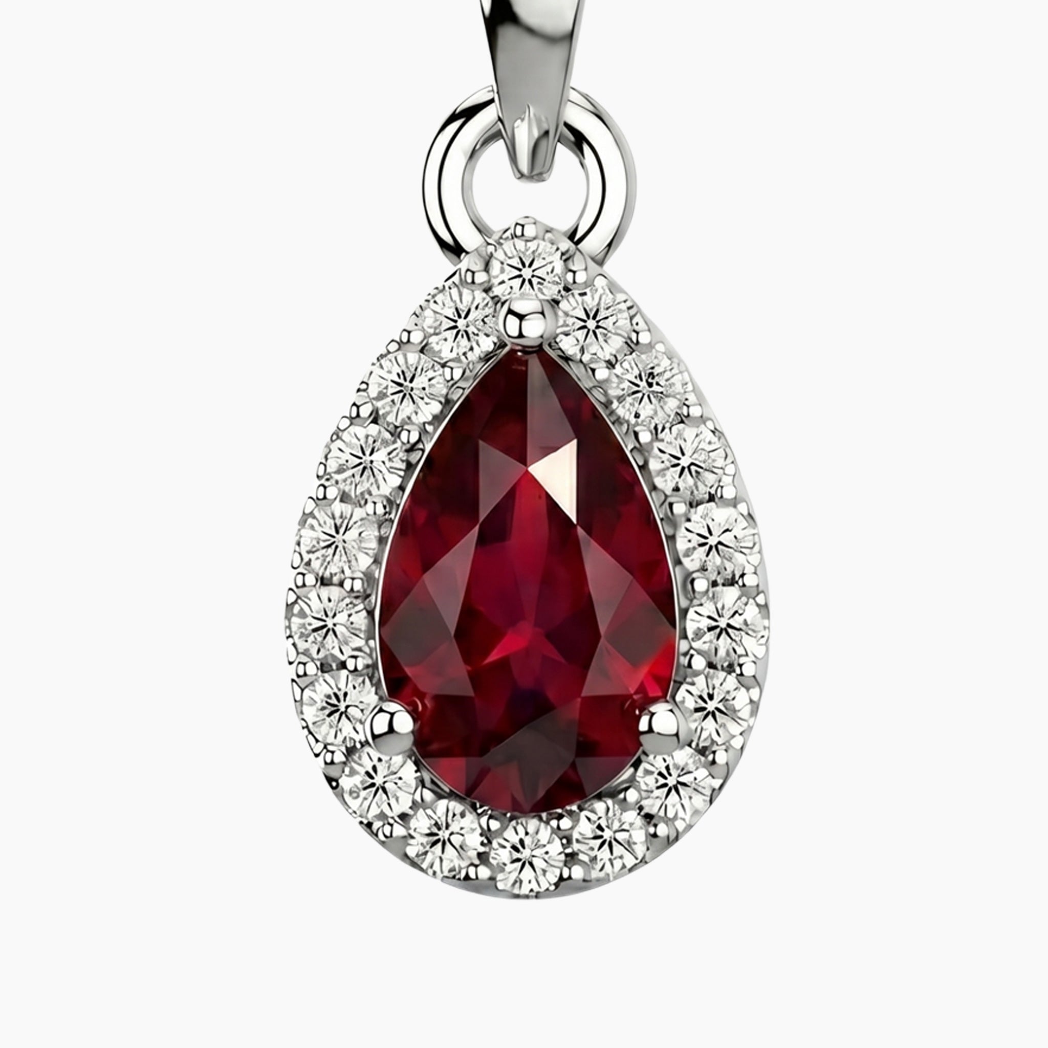 Teardrop-shaped ruby gemstone pendant with silver frame on a white background