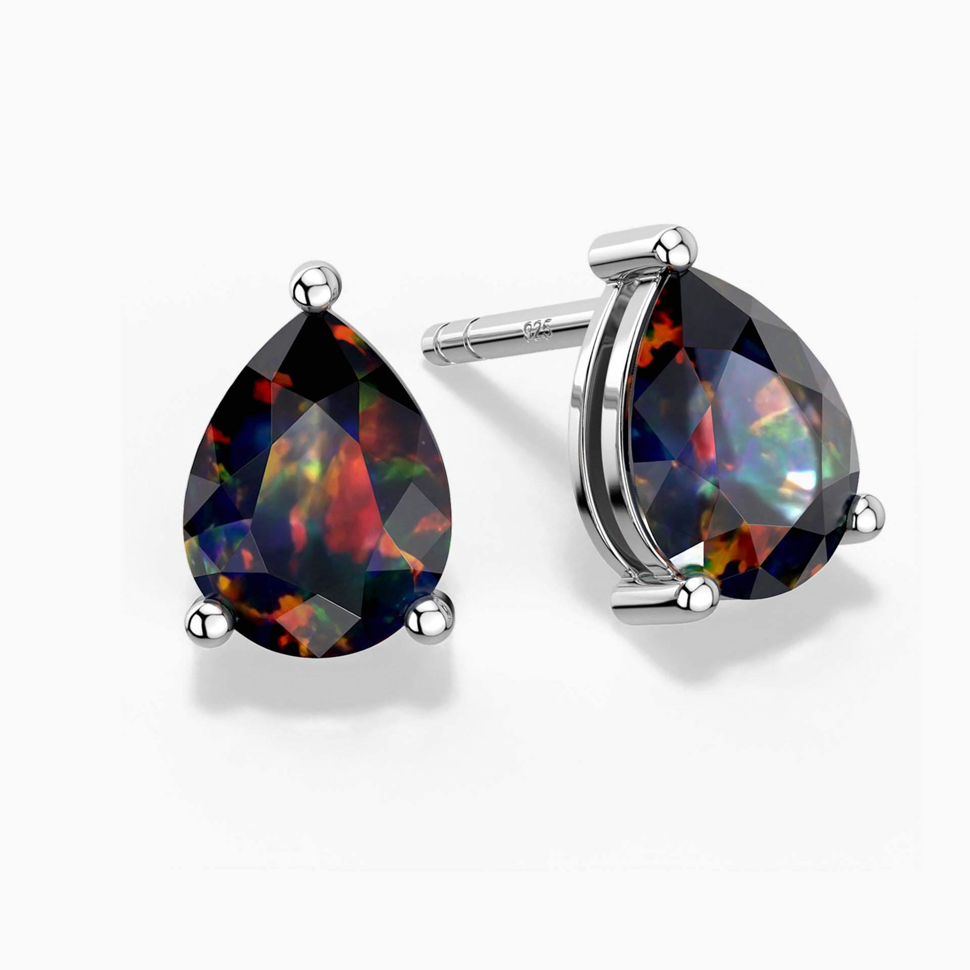 Two pear-shaped black opal stud earrings in three-prong sterling silver settings—one shown head-on and the other at a slight angle—displaying vivid flashes of red, green, and blue play-of-color against the opals’ dark base on a white background.