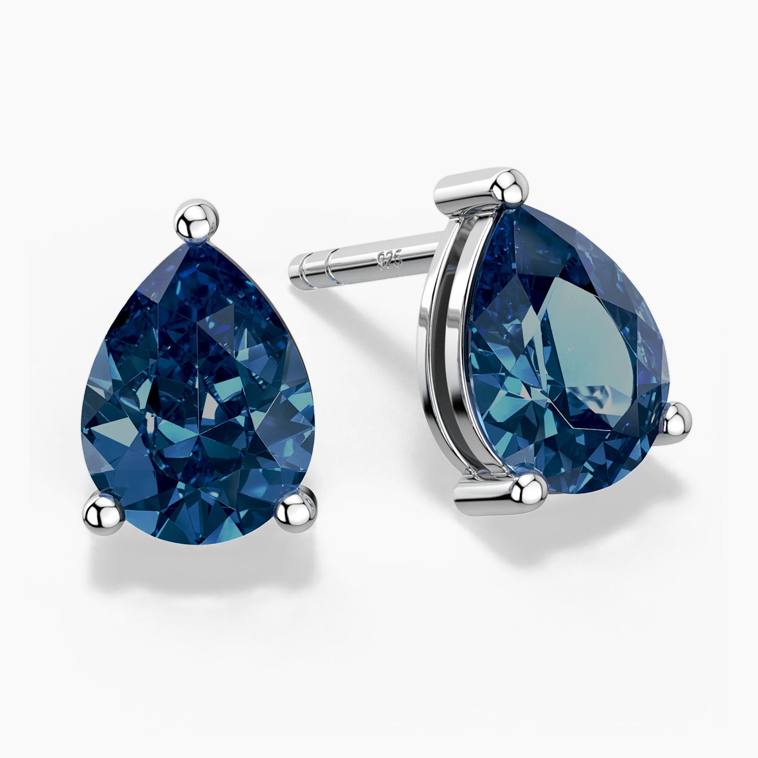 Pear-shaped London blue topaz stud earrings in sterling silver, shown in front and side views.