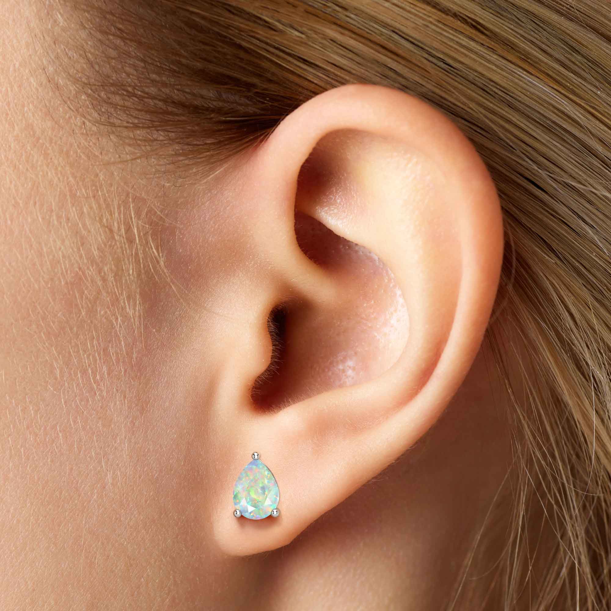 white opal pear stud earrings on model teardrop shape