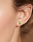 Model wearing Oval Silver Peridot Earrings in Sterling Silver
